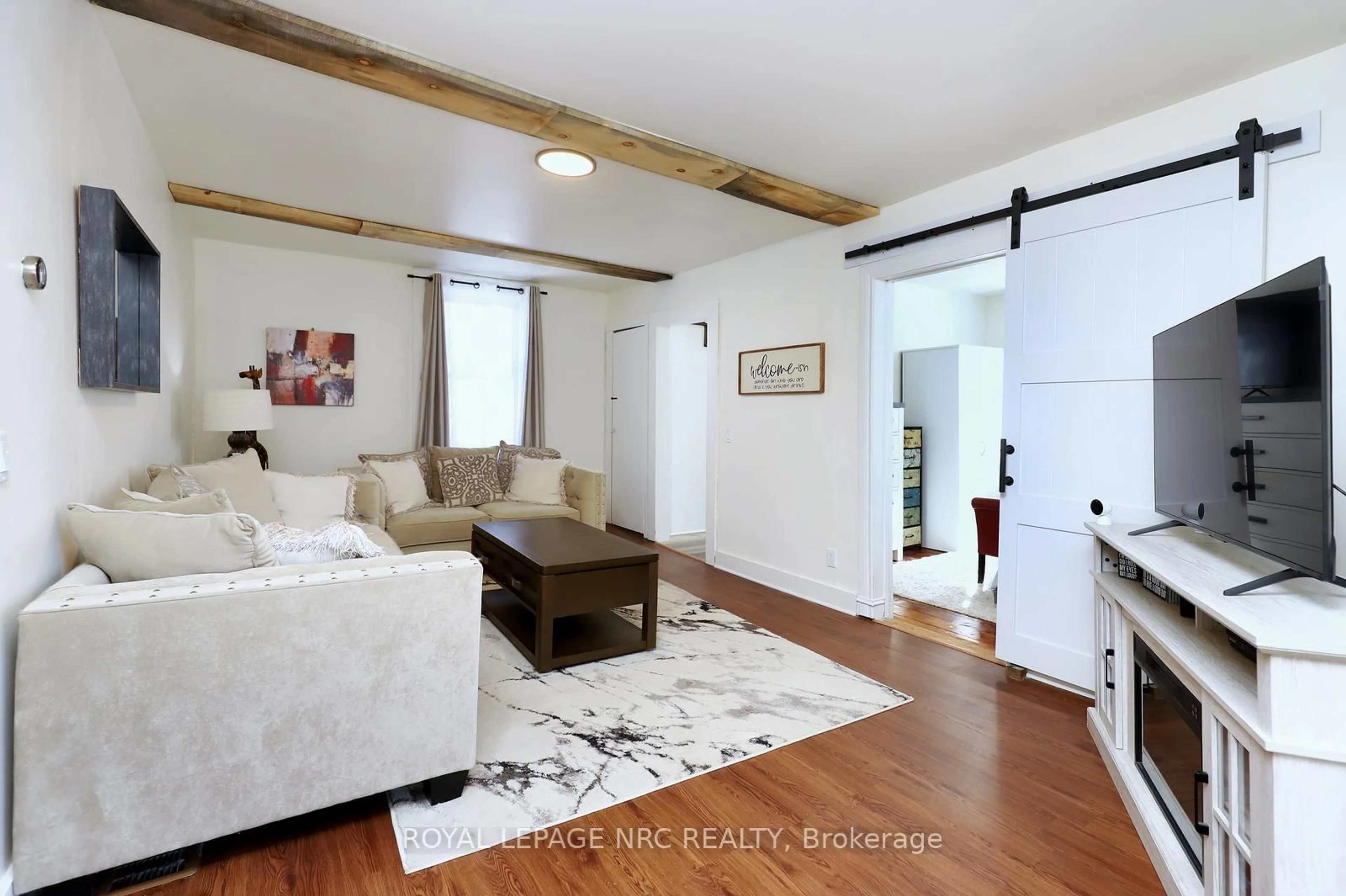 Living room with furniture, wood/laminate floor for 1 John Ave, Brant Ontario N3L 2S8