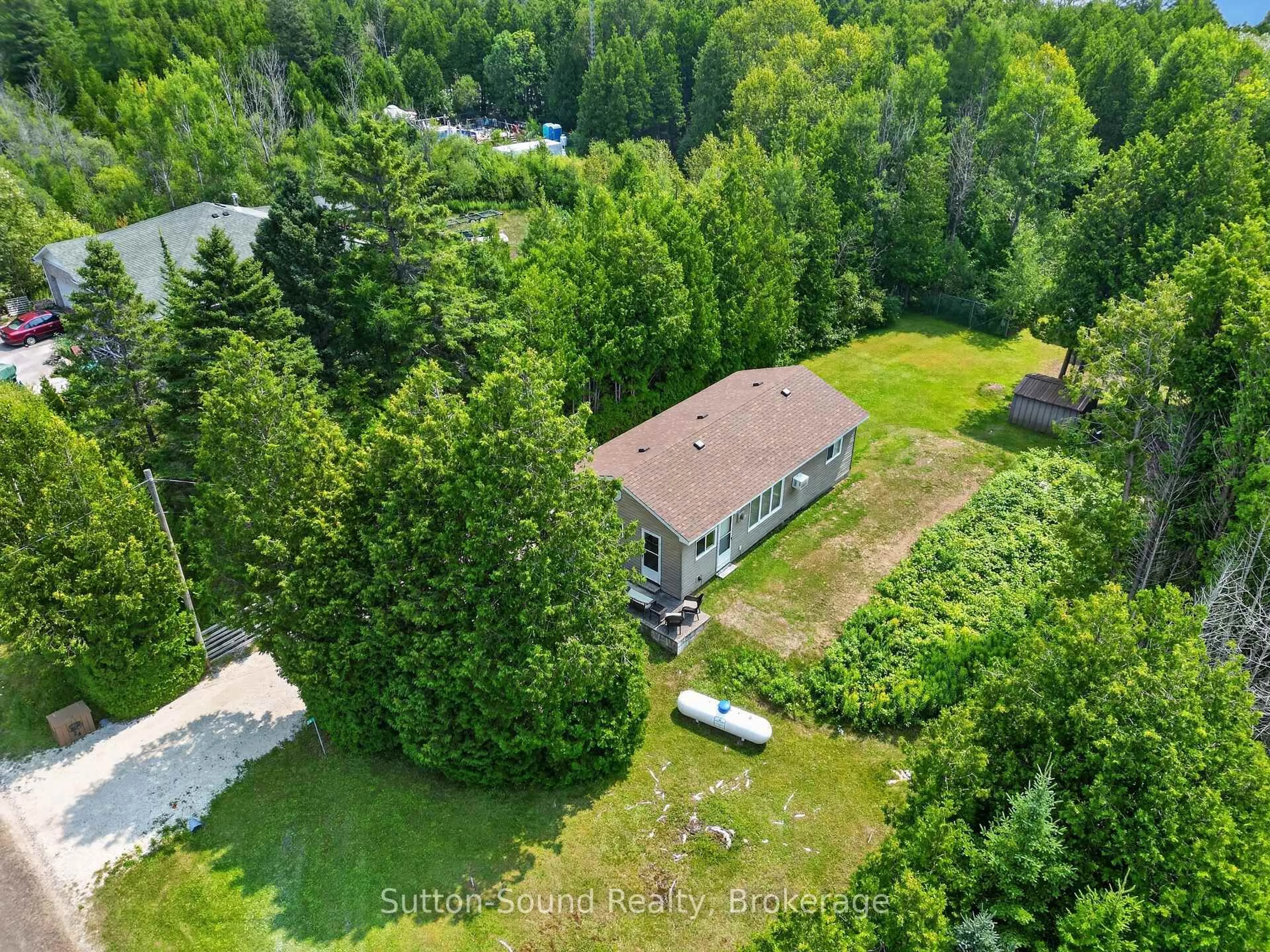 A pic from outside/outdoor area/front of a property/back of a property/a pic from drone, forest/trees view for 24 Isabella St, South Bruce Peninsula Ontario N0H 2T0