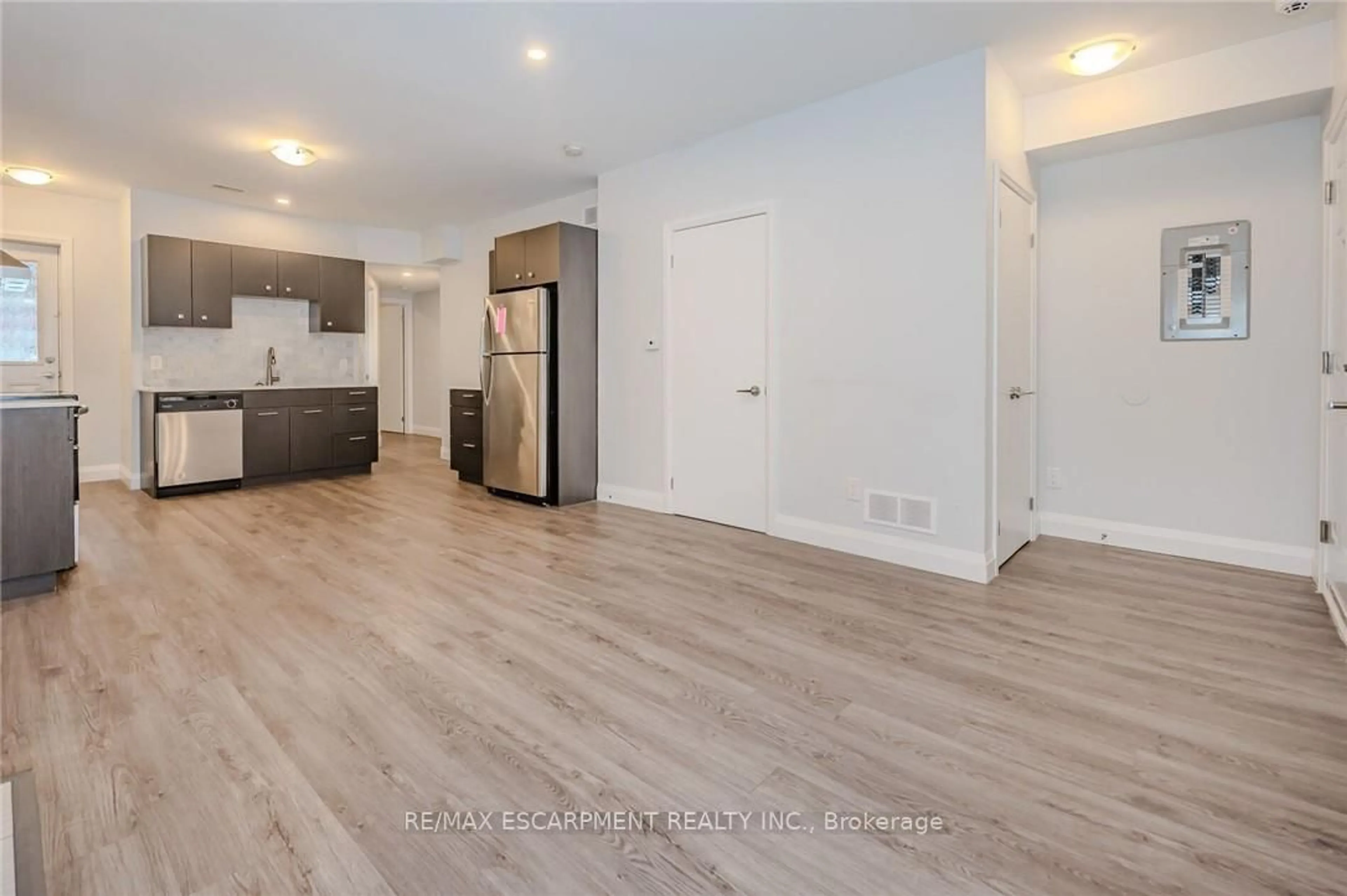 Open concept kitchen, wood/laminate floor for 74 Cathcart St, Hamilton Ontario L8R 1M5