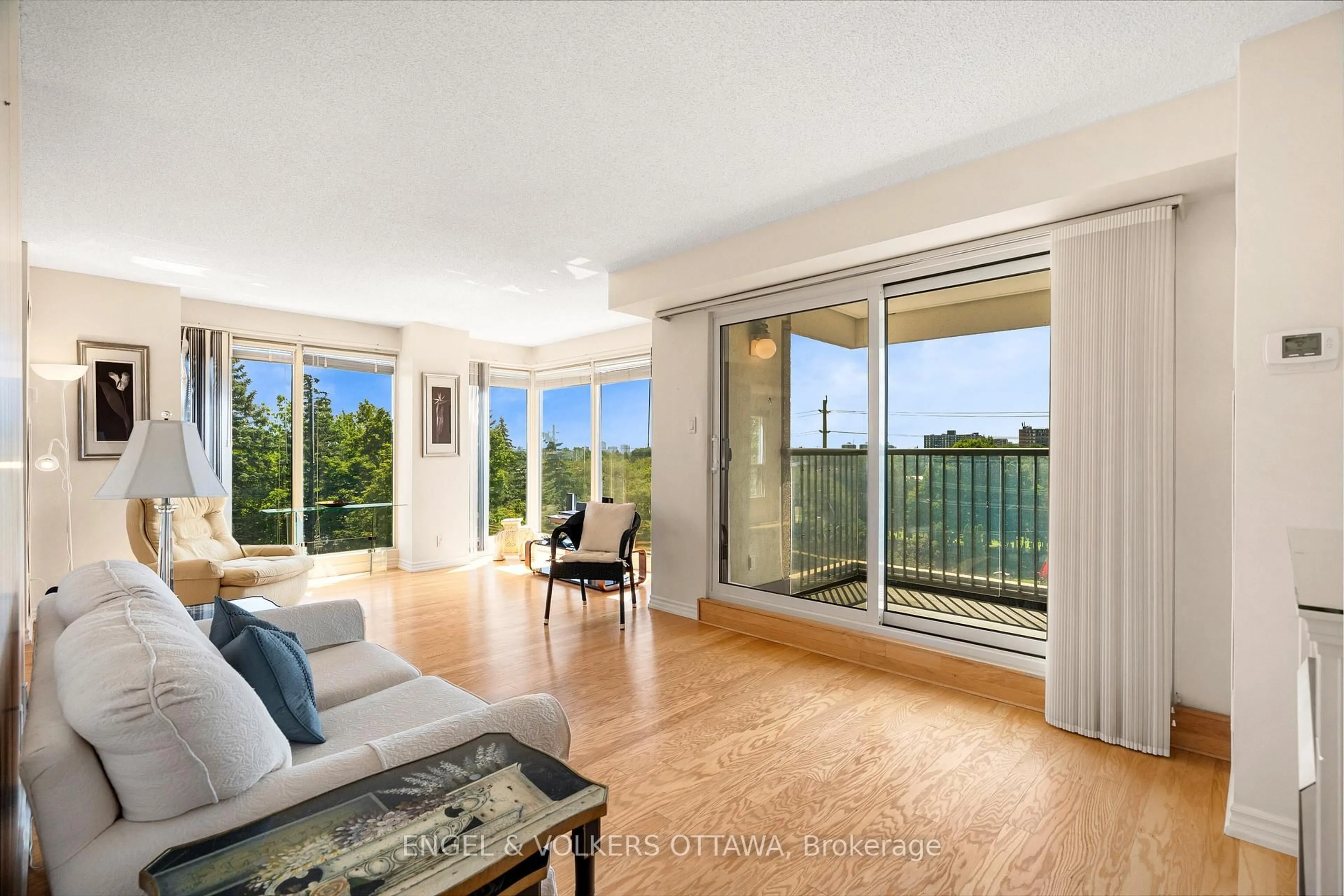 Living room with furniture, wood/laminate floor for 545 St Laurent Blvd #205, Ottawa Ontario K1K 4H9