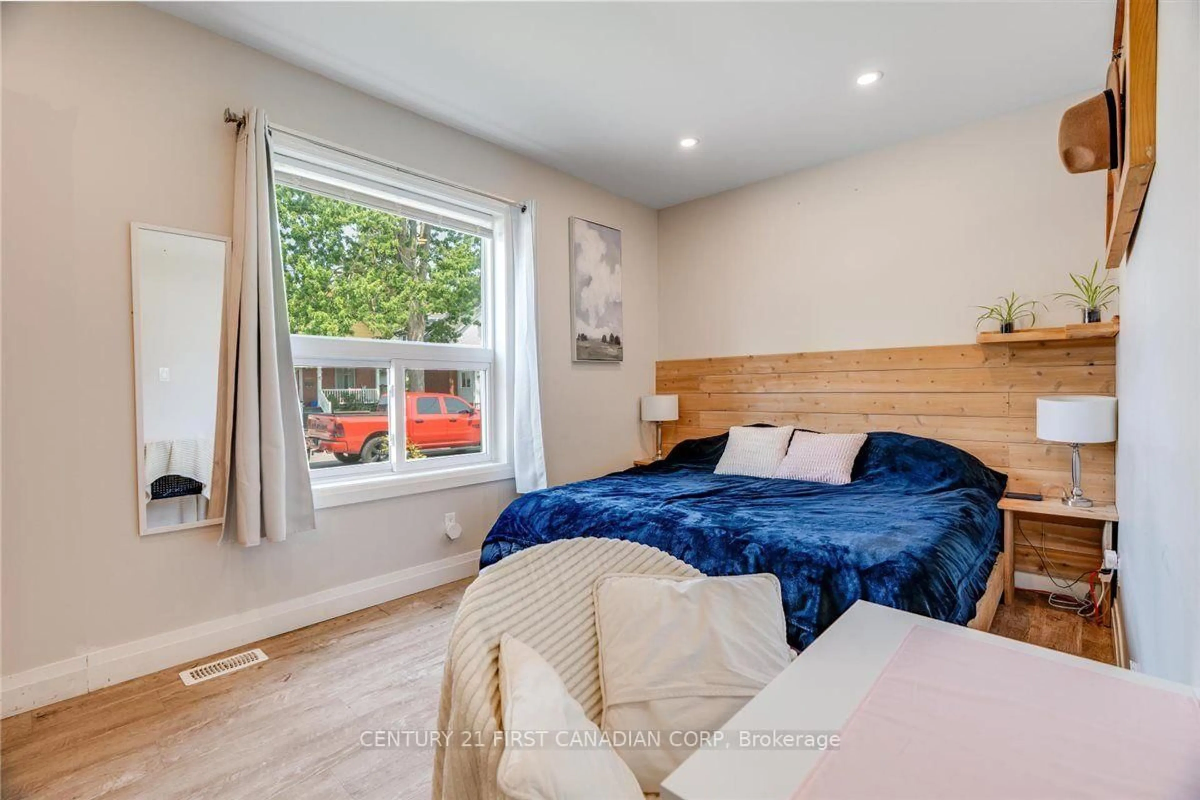 Bedroom with bed, wood/laminate floor for 1025 King St, London East Ontario N5W 2X7