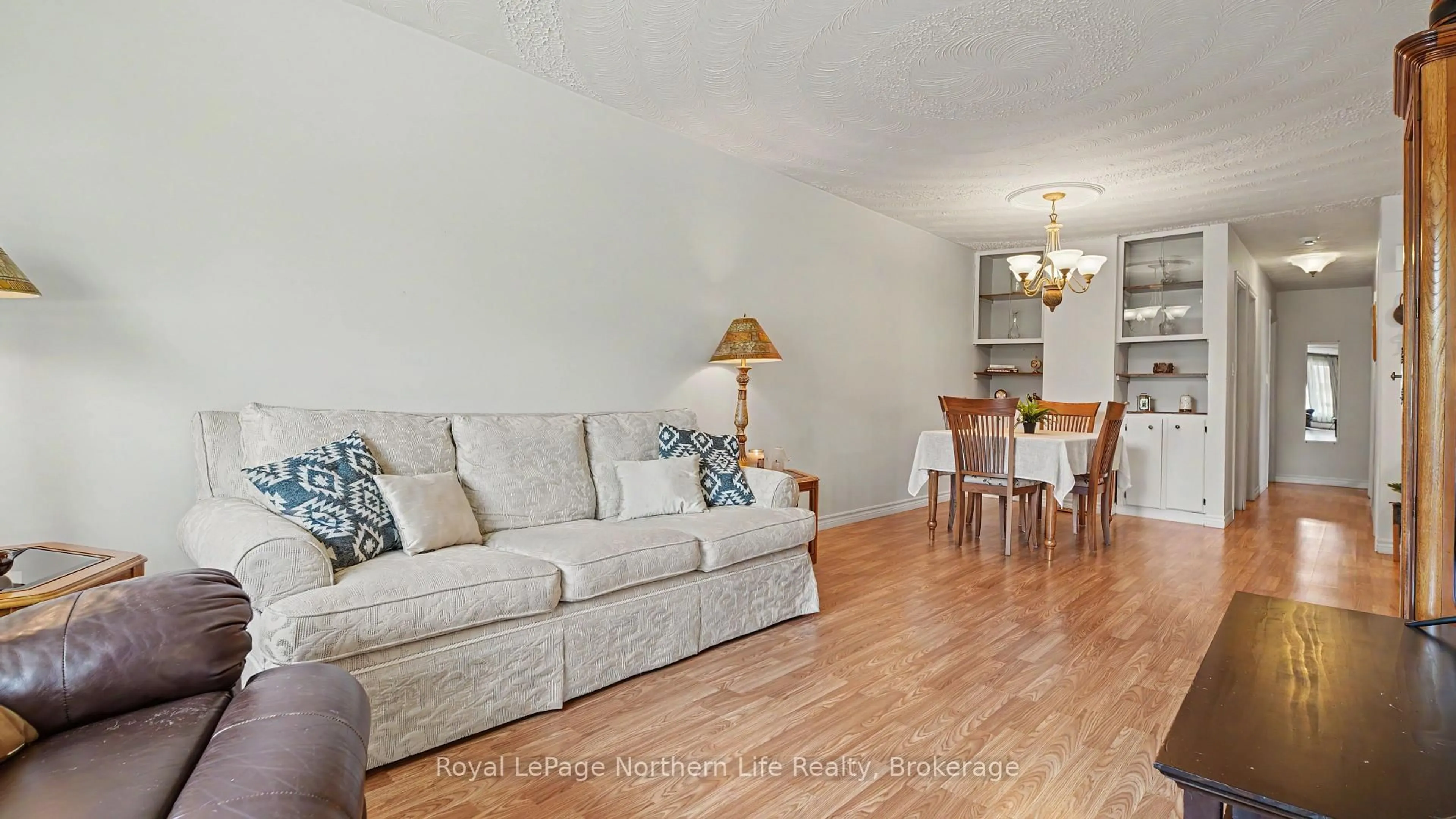 Living room with furniture, wood/laminate floor for 29 Pollard Ave, North Bay Ontario P1A 1Z4