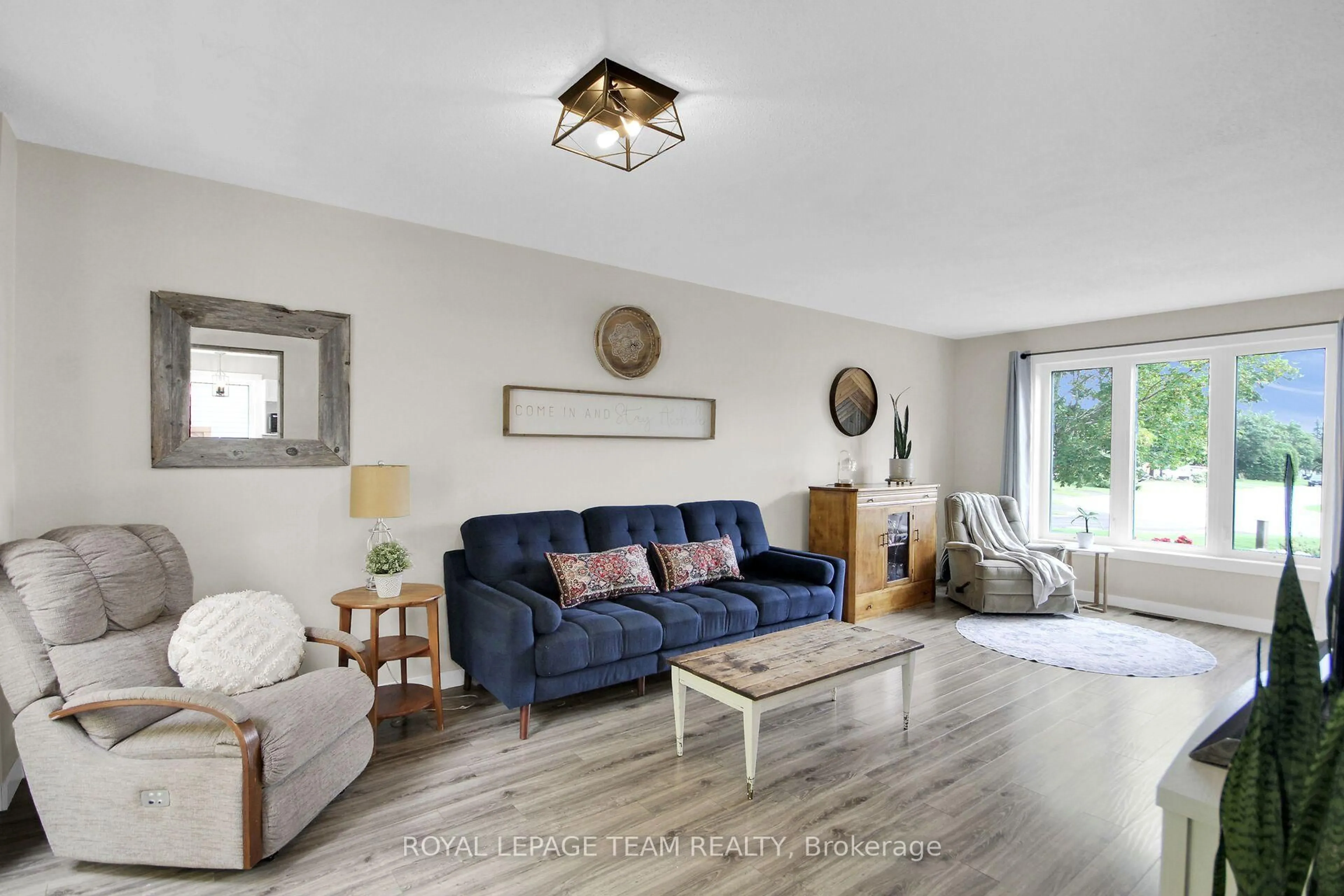 Living room with furniture, wood/laminate floor for 36 Steggall Cres, Stittsville Ontario K2S 1S4