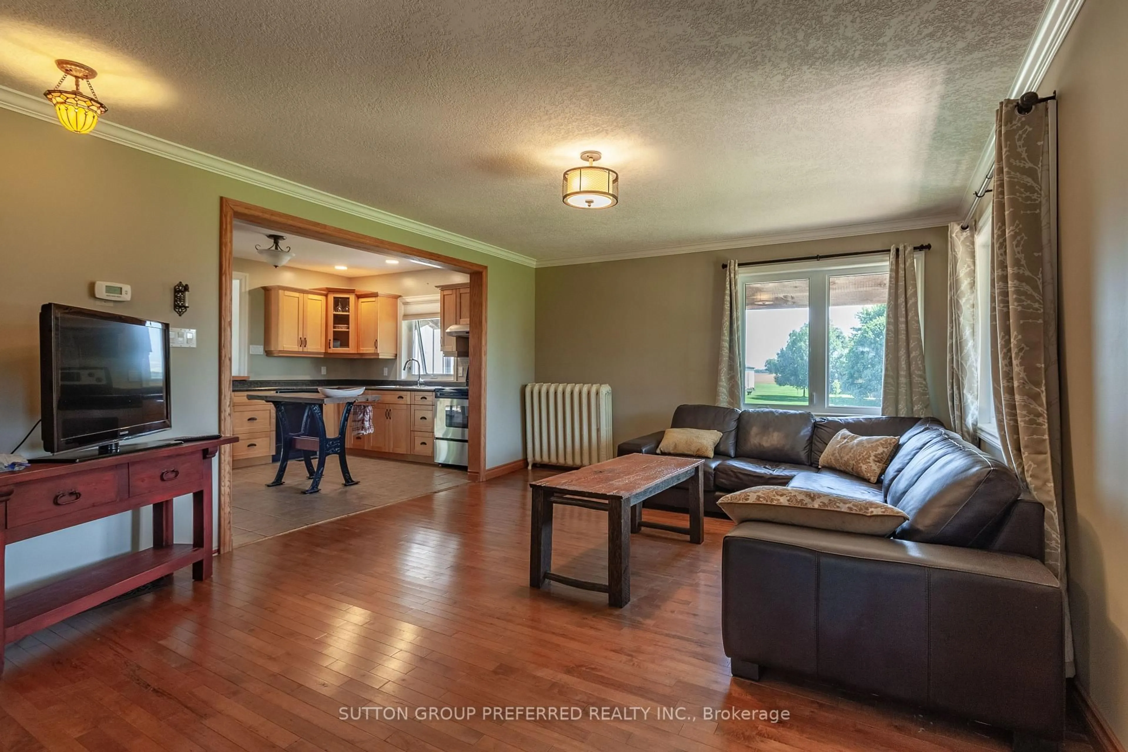 Living room with furniture, wood/laminate floor for 47094 Lyons Line, Malahide Ontario N0L 1B0