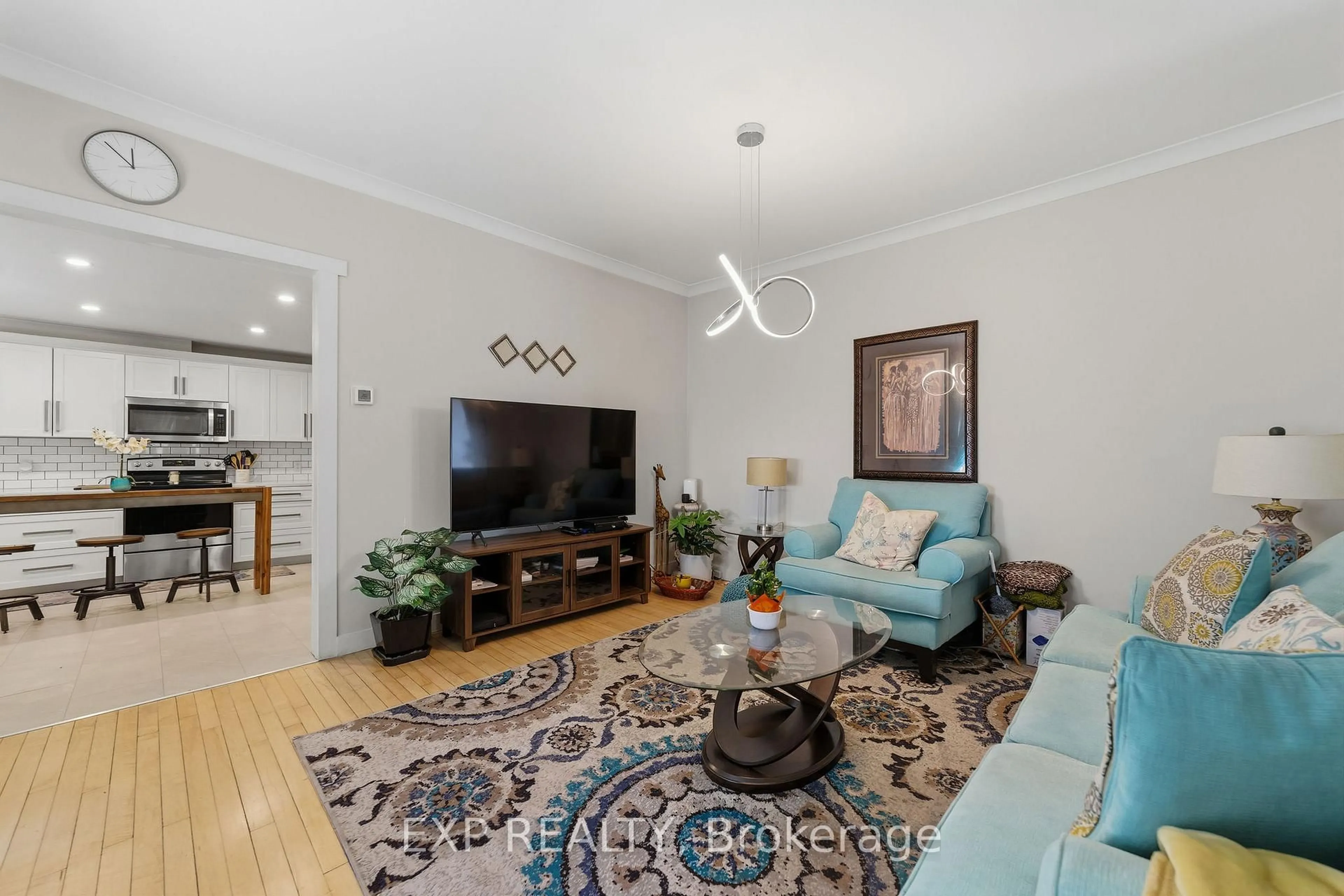 Living room with furniture, wood/laminate floor for 29 Winniett St, Woodstock Ontario N4S 5Z4