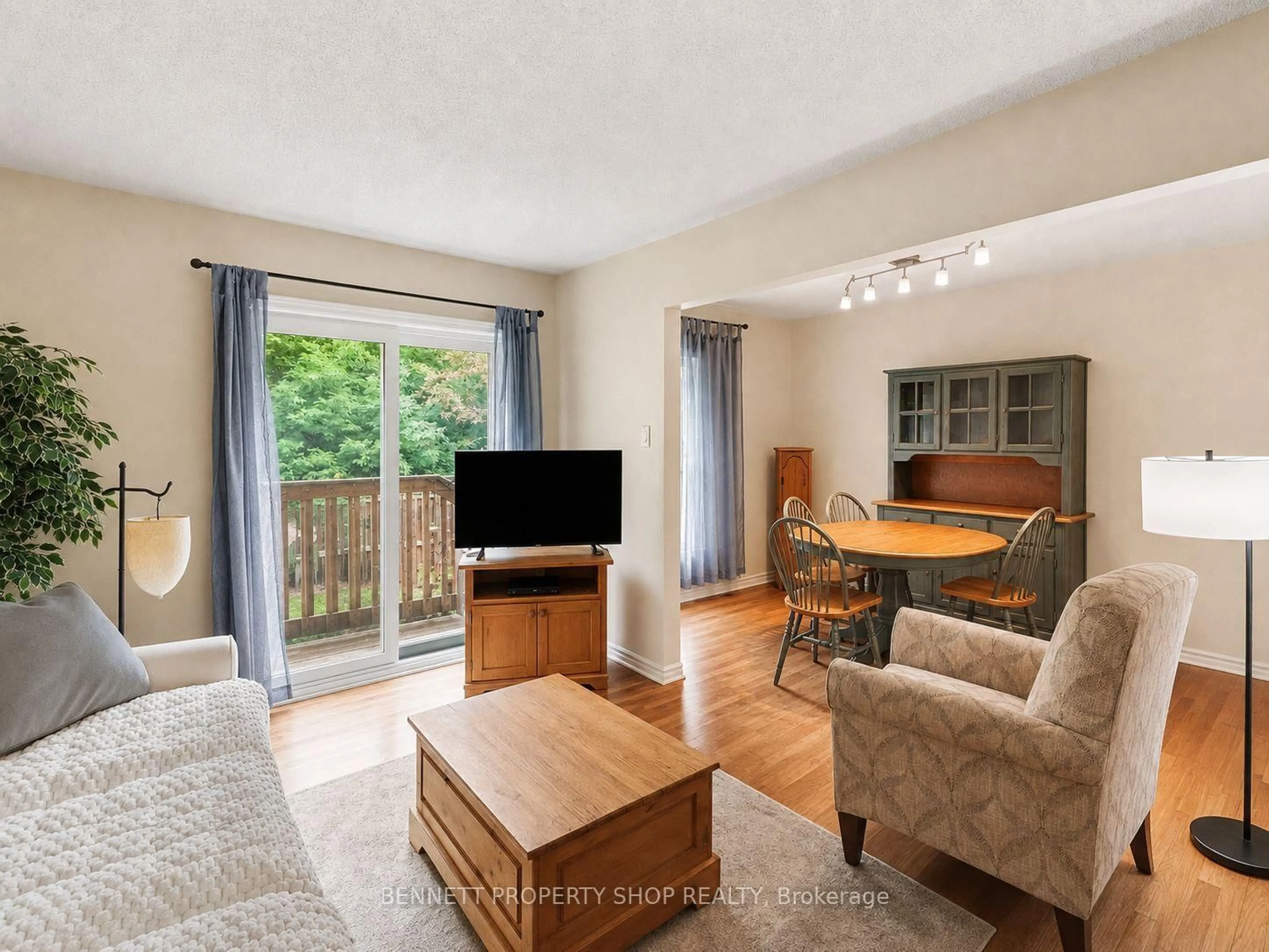 Living room with furniture, wood/laminate floor for 3445 Uplands Dr #224, Ottawa Ontario K1V 9N6