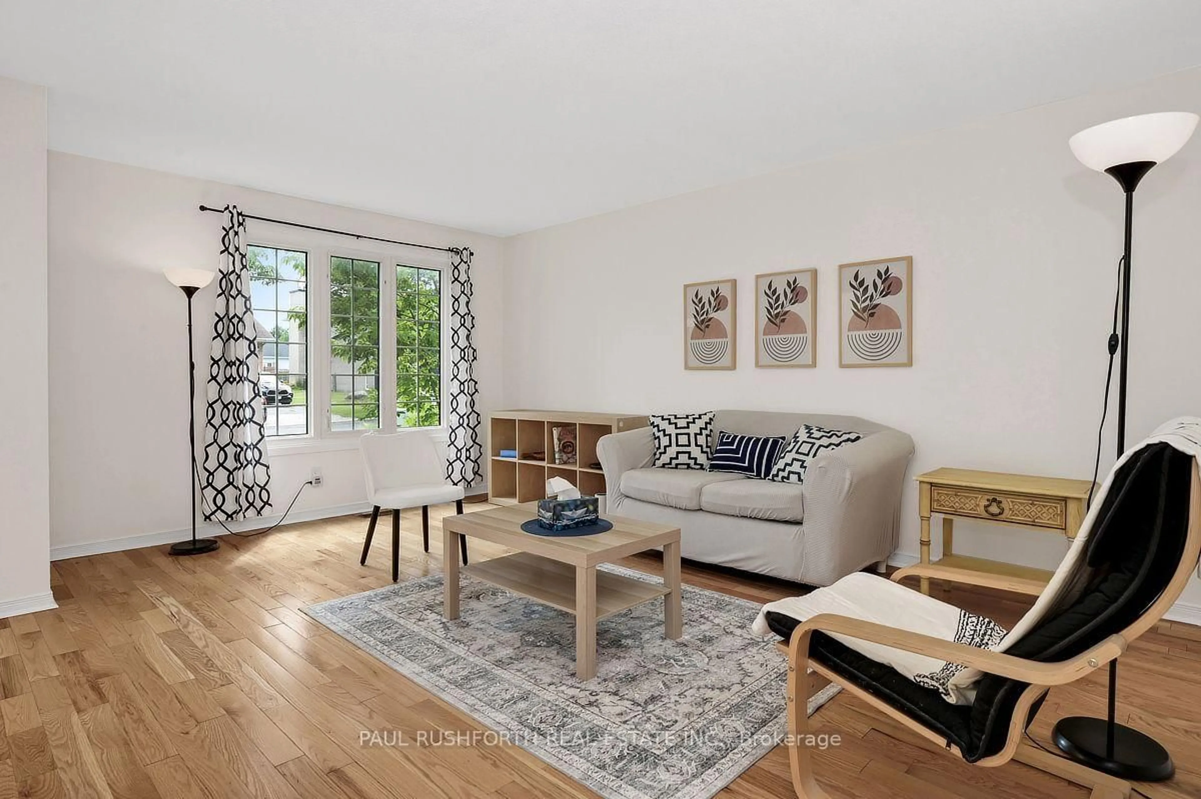 Living room with furniture, wood/laminate floor for 939 Greenbriar Ave, Ottawa Ontario K2C 0J8