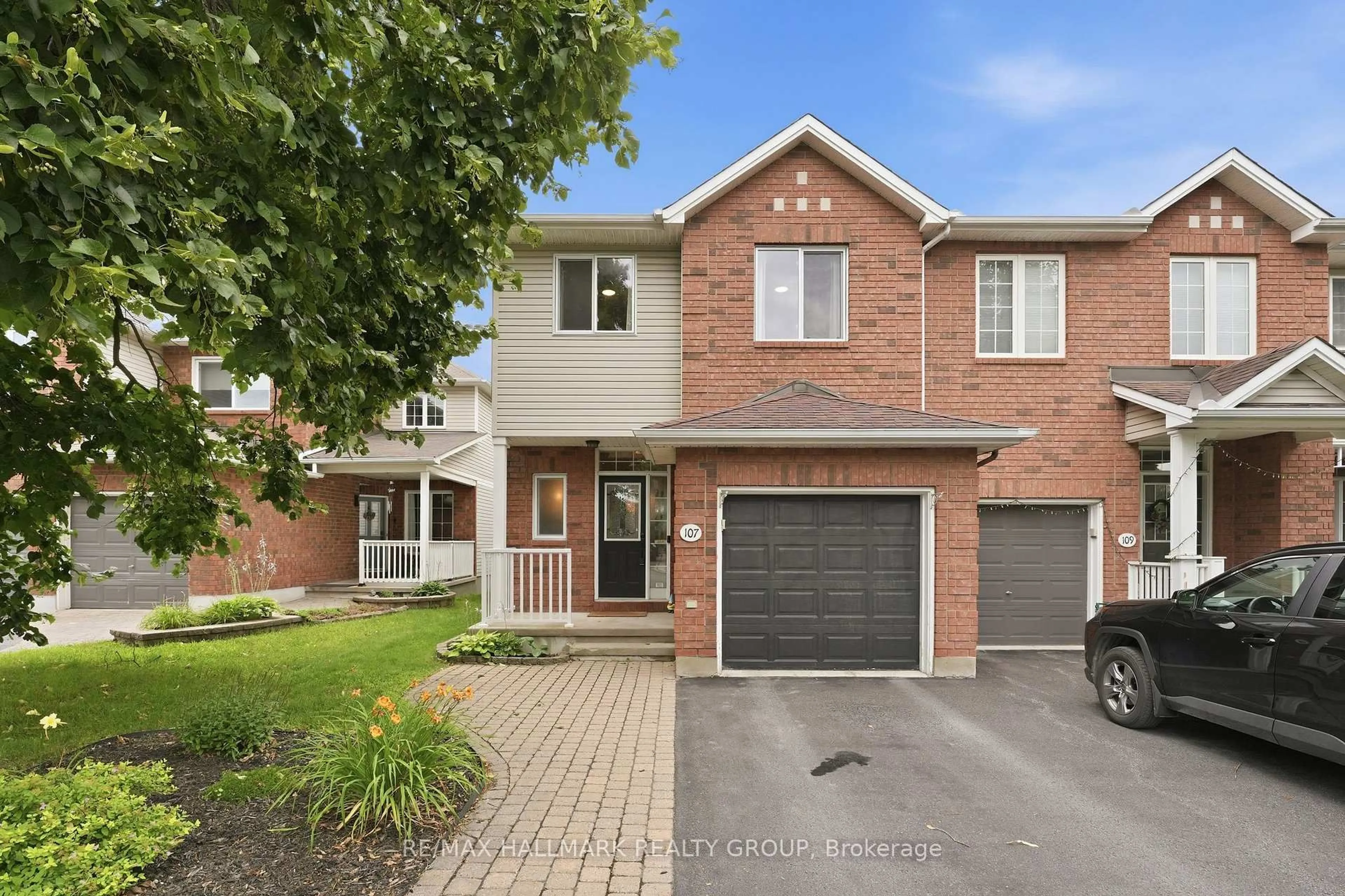 Home with brick exterior material, street for 107 Bishops Mills Way, Ottawa Ontario K2K 3C2