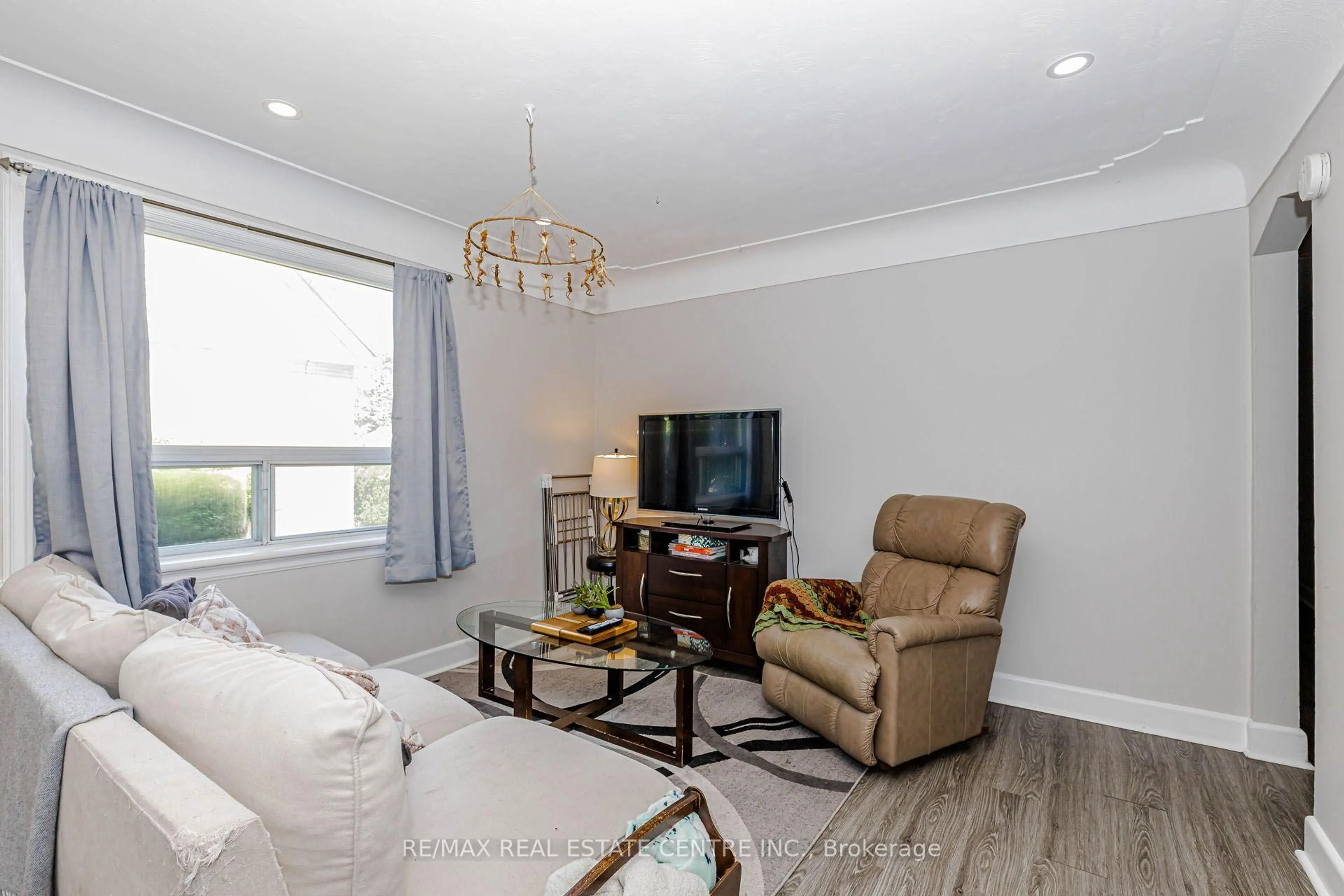 Living room with furniture, wood/laminate floor for 16 Ainslie Ave, Hamilton Ontario L8S 2J3