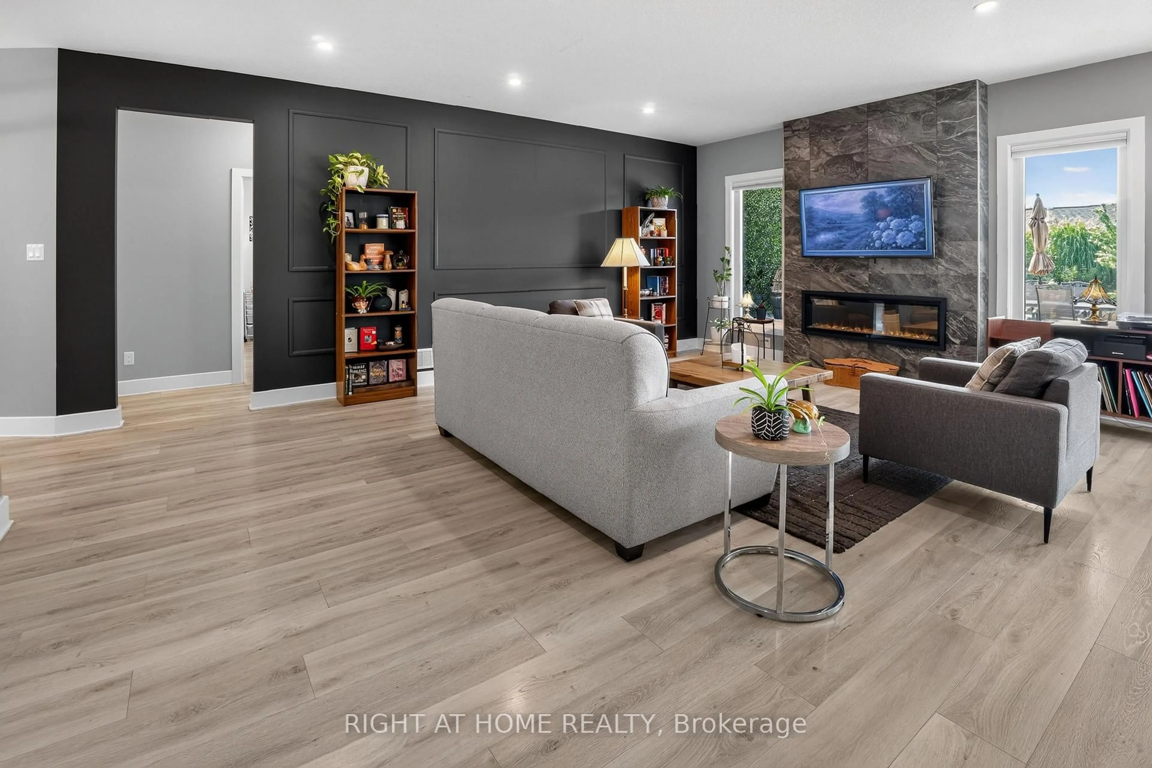 Living room with furniture, wood/laminate floor for 57 Talbot Grove Lane, Southwold Ontario N5P 3T2