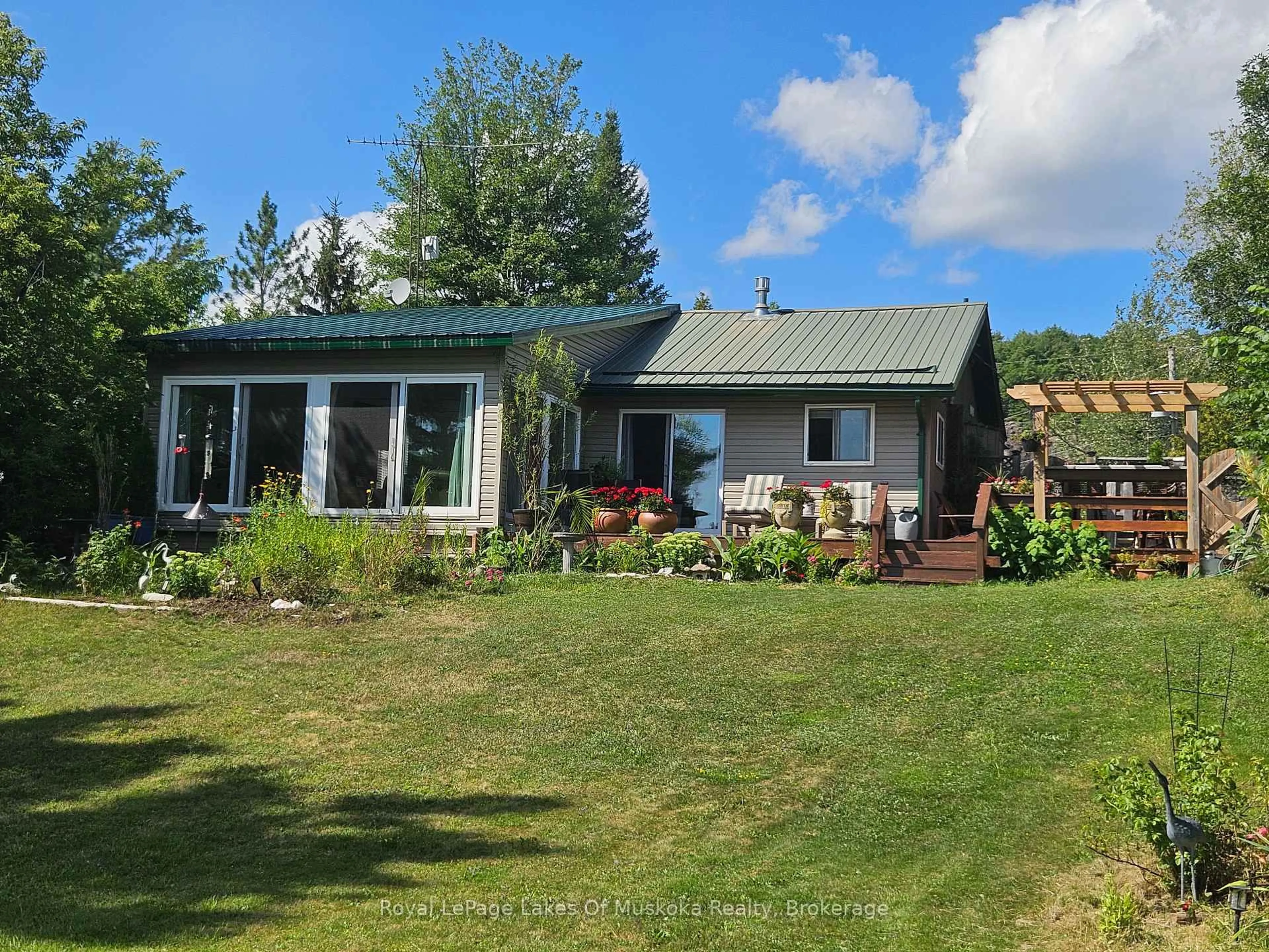 A pic from outside/outdoor area/front of a property/back of a property/a pic from drone, water/lake/river/ocean view for 1052 Cove Rd #1, Muskoka Lakes Ontario P0B 1M0