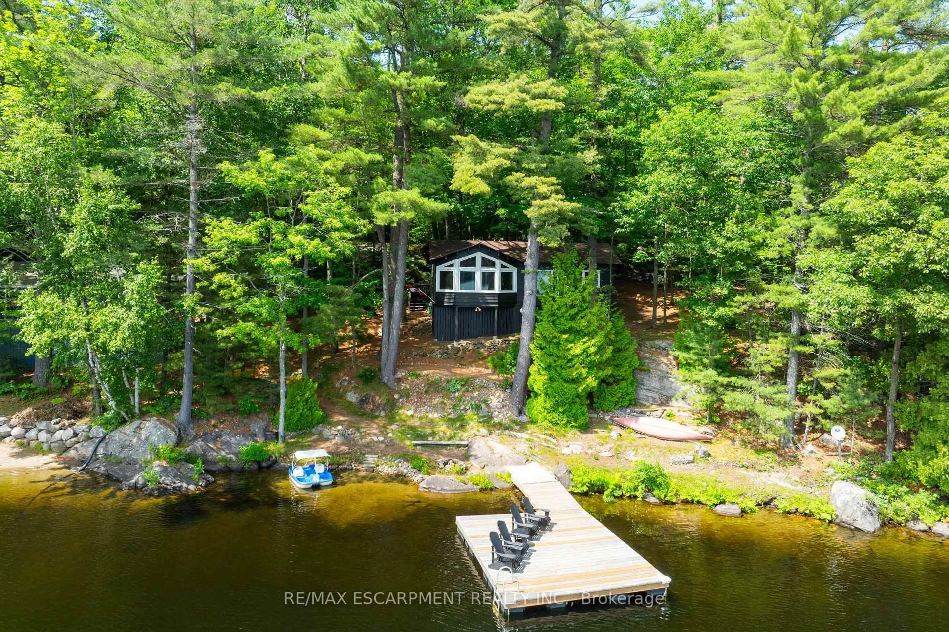 A pic from outside/outdoor area/front of a property/back of a property/a pic from drone, water/lake/river/ocean view for 1009 Fogo St, Muskoka Lakes Ontario P0C 1H0