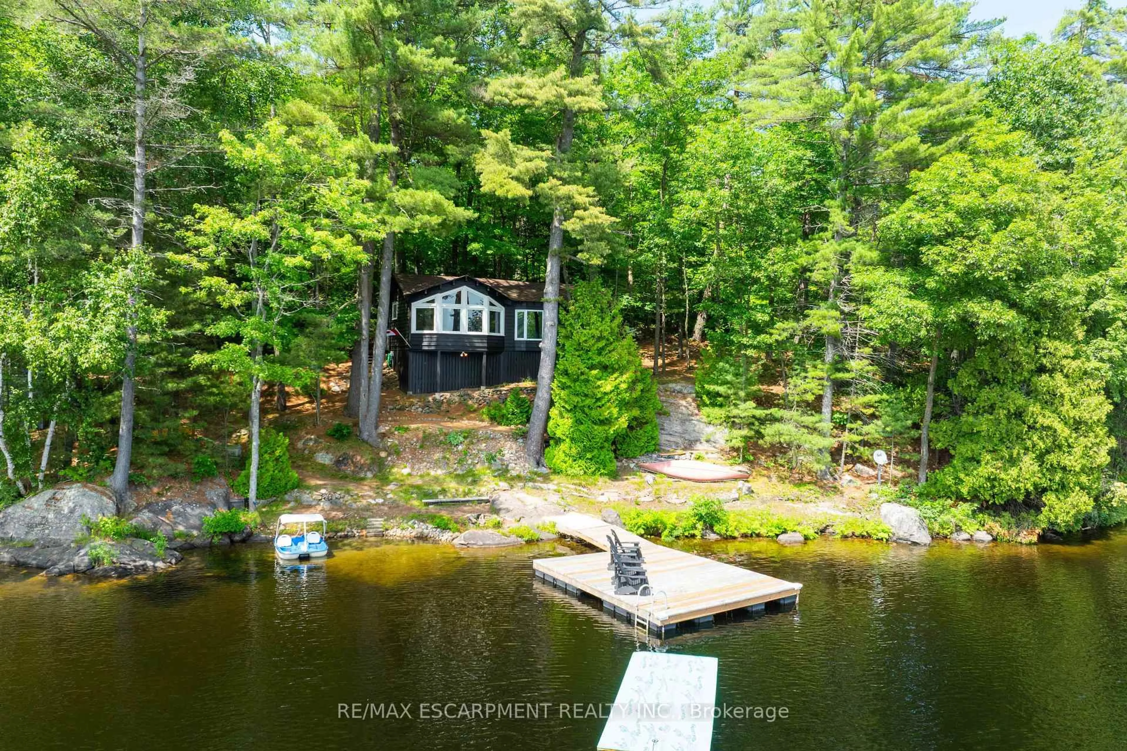 A pic from outside/outdoor area/front of a property/back of a property/a pic from drone, water/lake/river/ocean view for 1009 Fogo St, Muskoka Lakes Ontario P0C 1H0