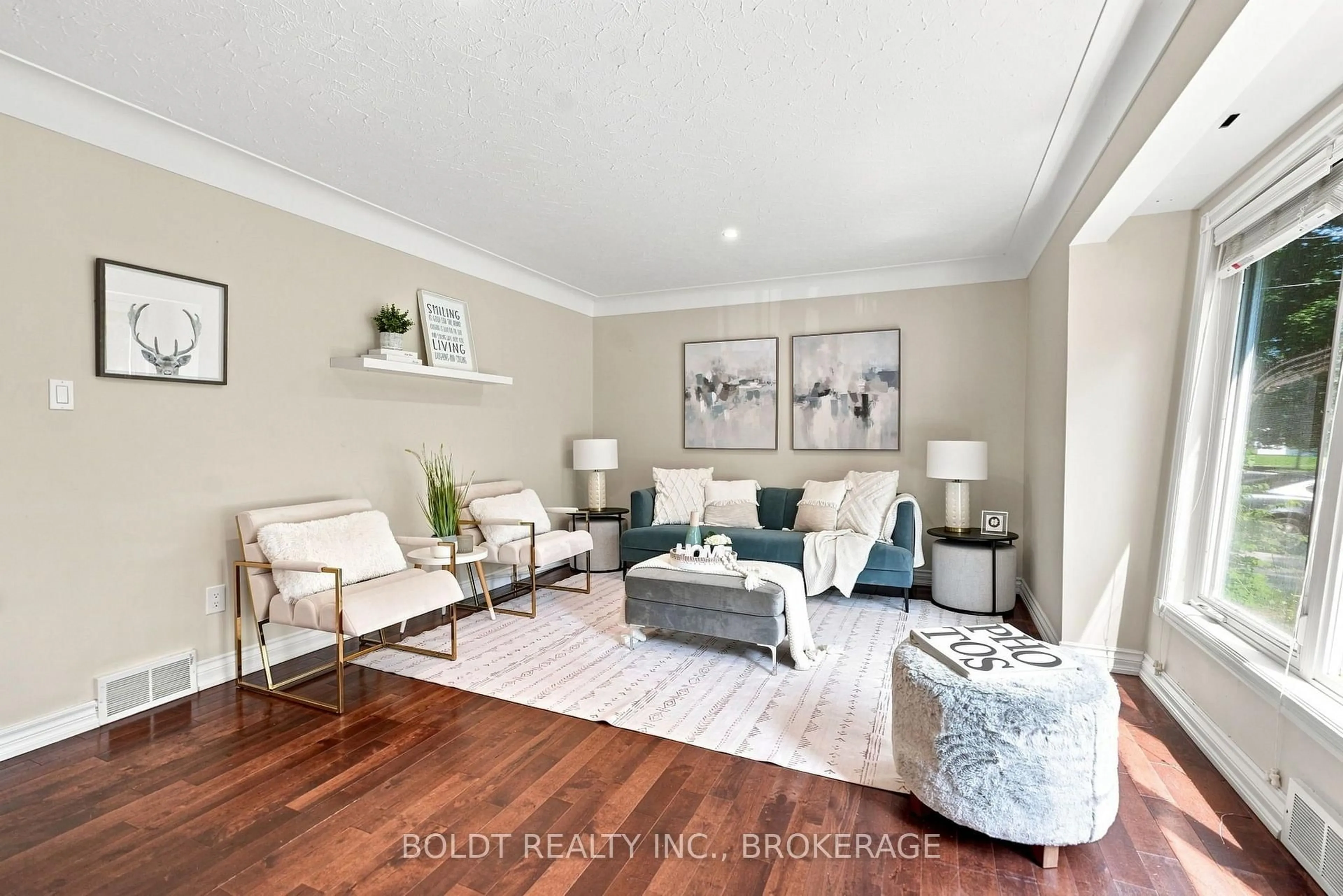 Living room with furniture, wood/laminate floor for 23 Woodelm Dr, St. Catharines Ontario L2M 4N5