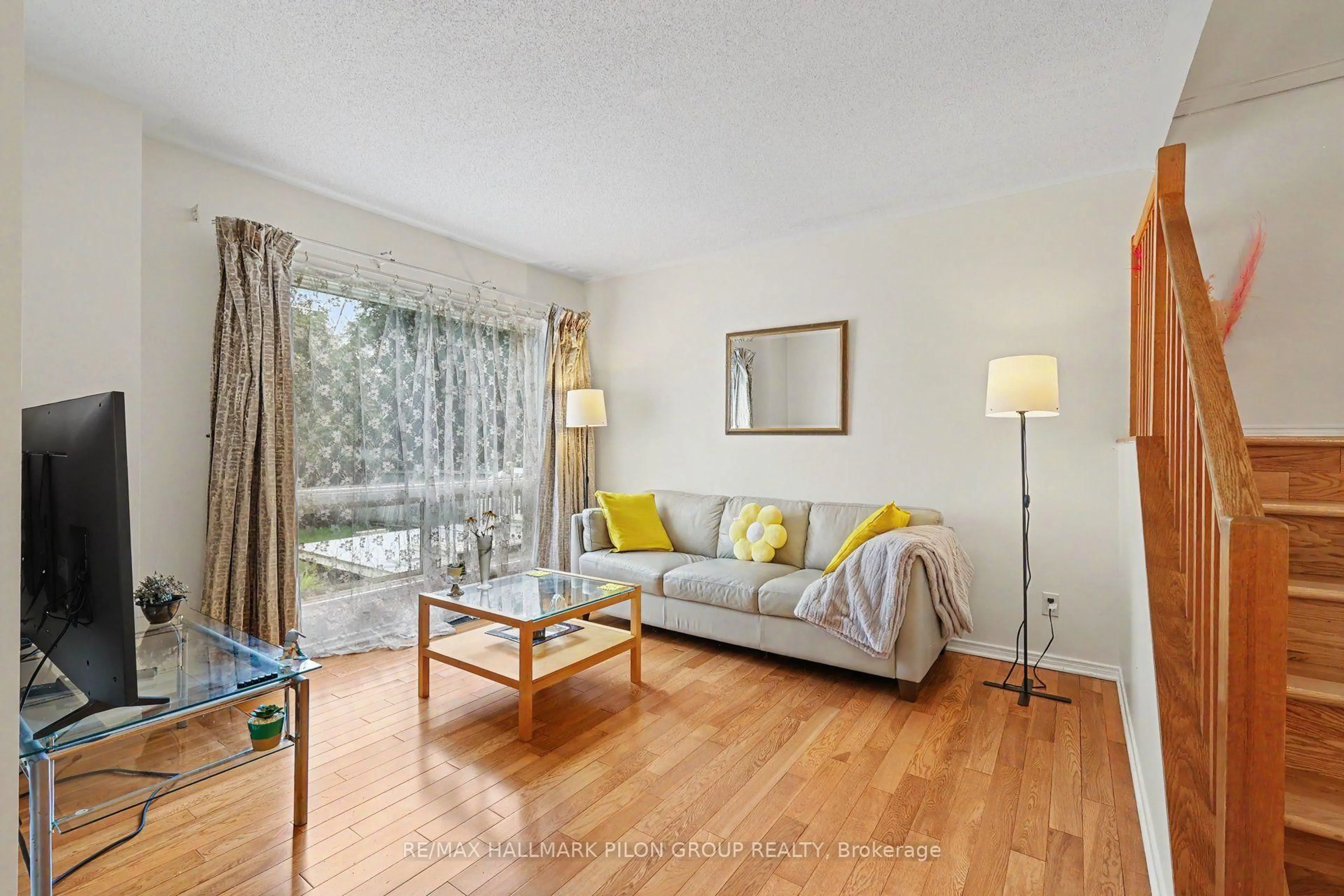 Living room with furniture, wood/laminate floor for 48 Jackman Terr, Ottawa Ontario K2L 4E1