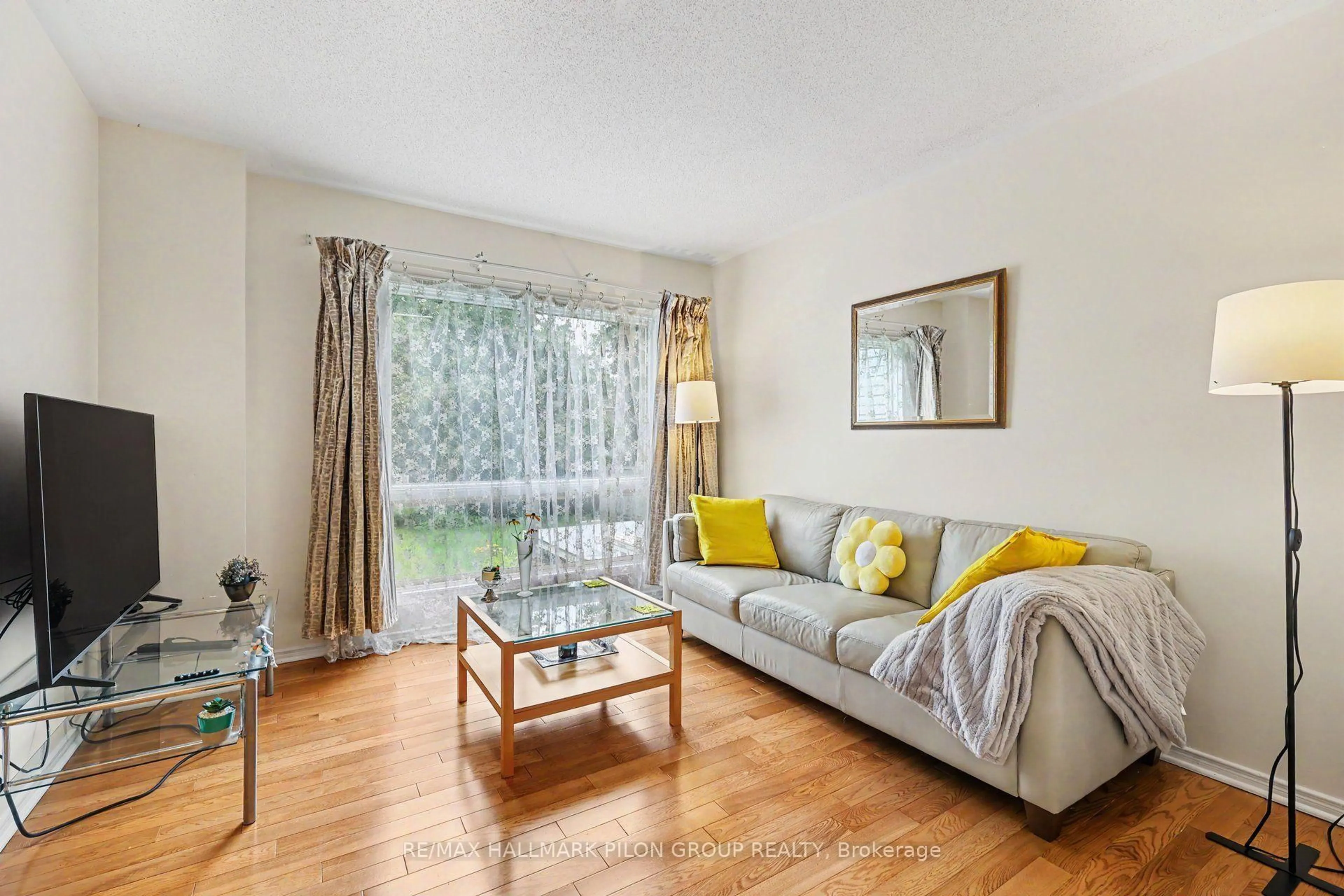 Living room with furniture, wood/laminate floor for 48 Jackman Terr, Ottawa Ontario K2L 4E1