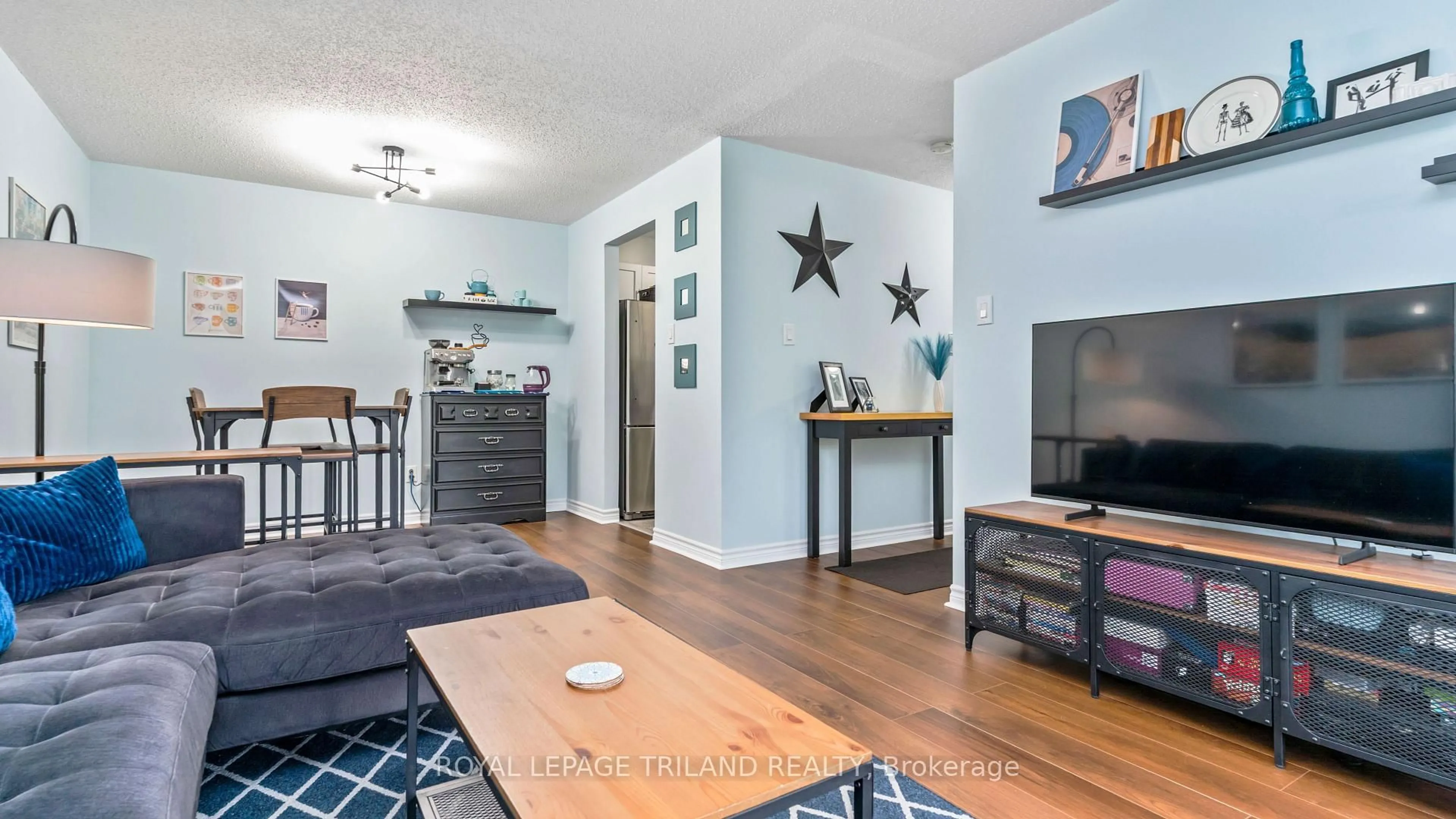 Living room with furniture, wood/laminate floor for 735 DEVERON Cres #116, London South Ontario N5Z 4X8