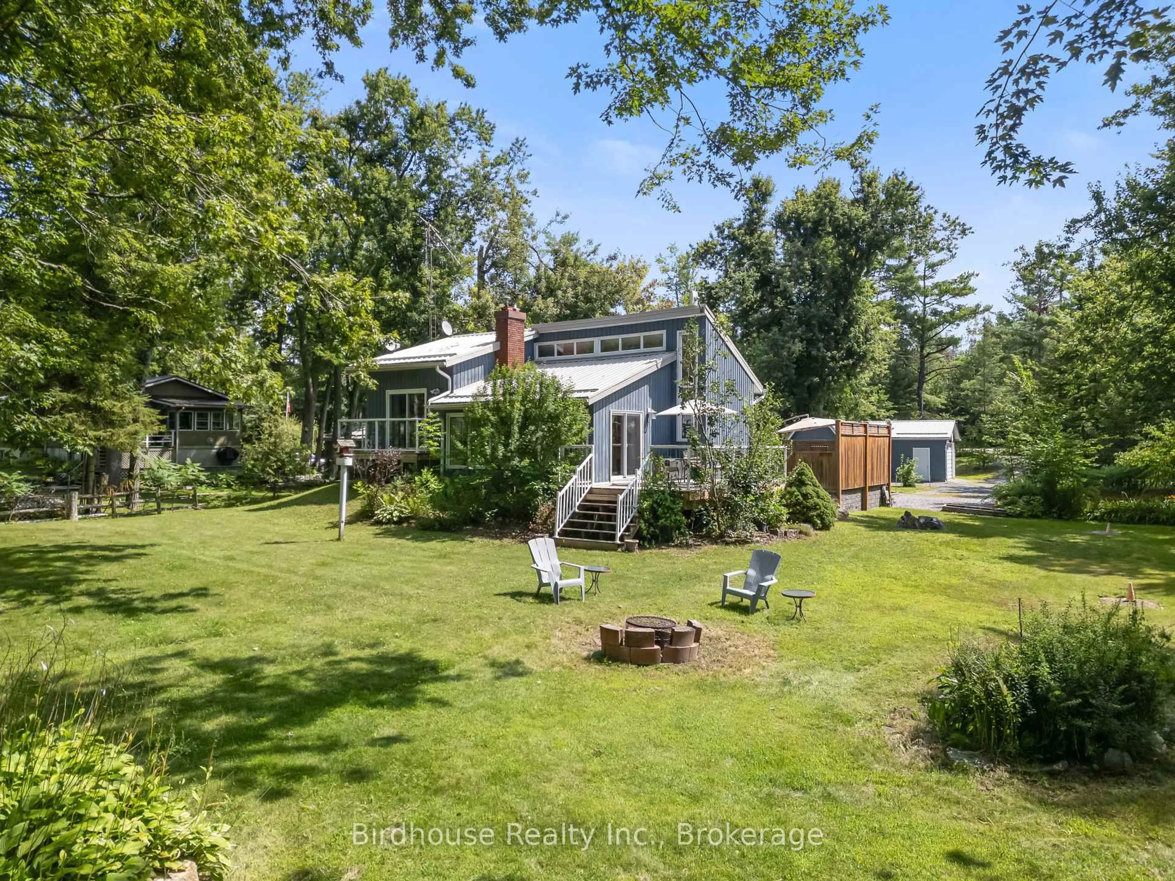 A pic from outside/outdoor area/front of a property/back of a property/a pic from drone, forest/trees view for 92 Edwina Dr, Trent Lakes Ontario K0M 1A0