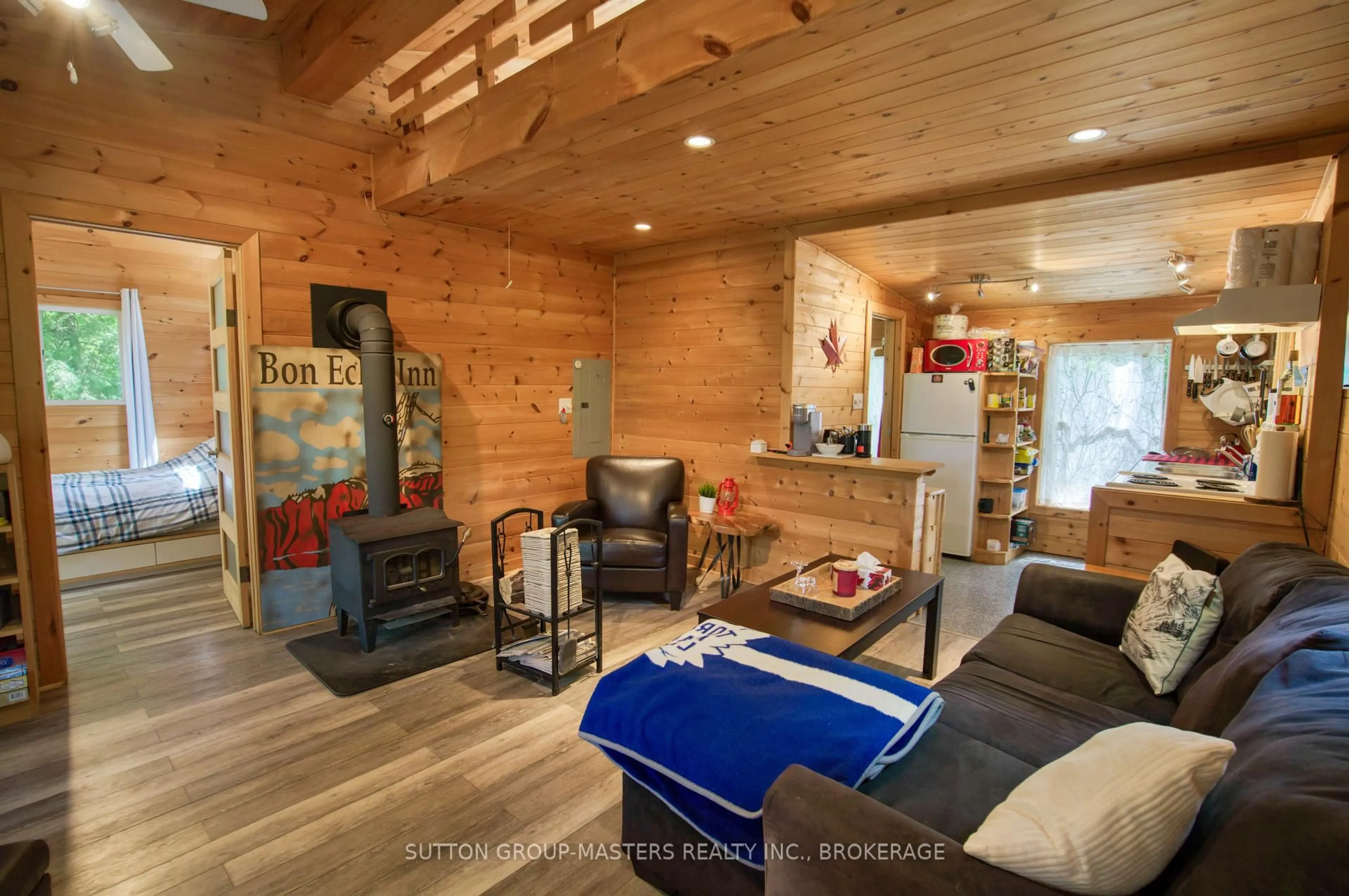 Living room with furniture, wood/laminate floor for 2282 Myers Cave Rd, Cloyne Ontario K0H 1K0