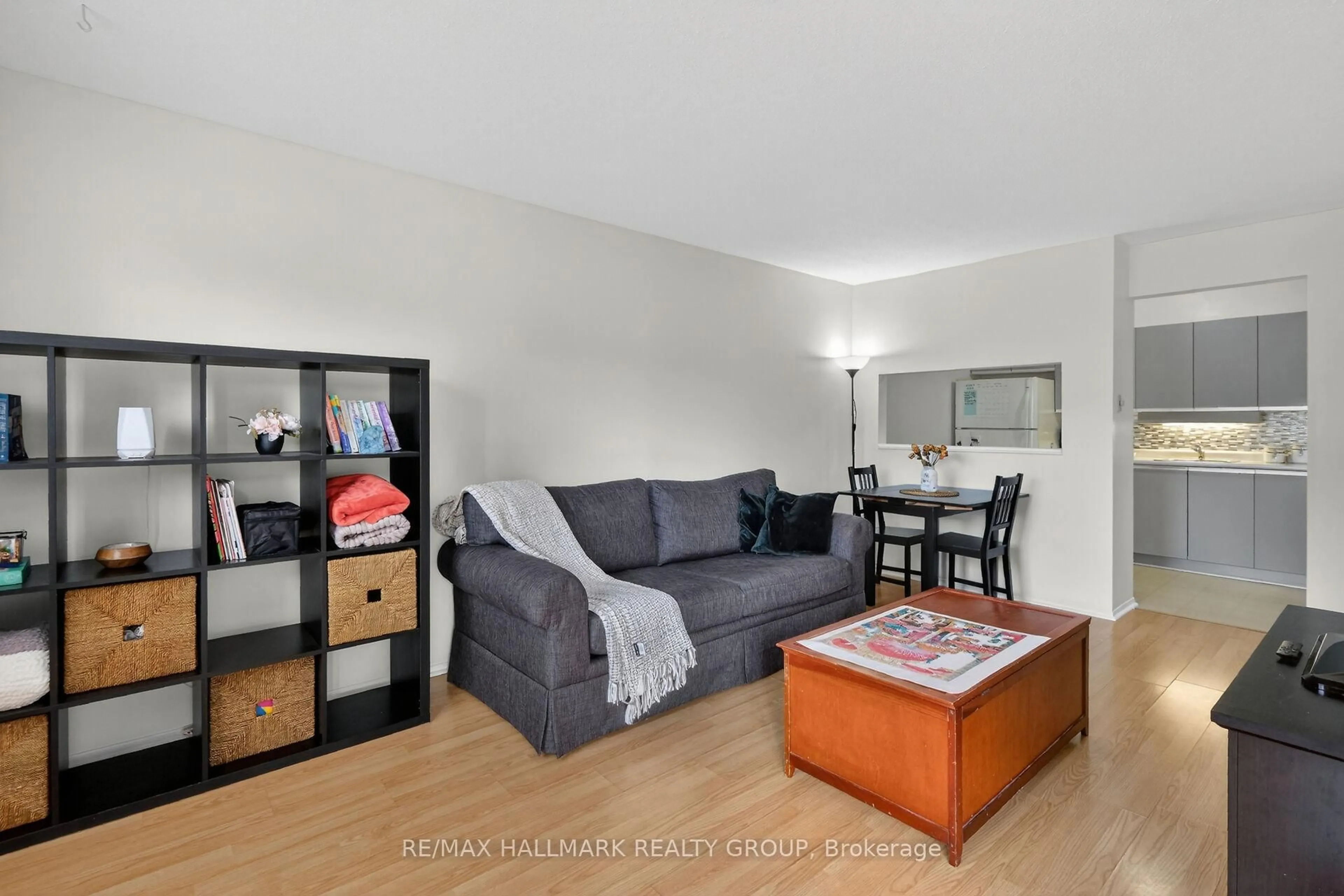 Living room with furniture, wood/laminate floor for 280 Brittany Dr #102, Ottawa Ontario K1K 4M4