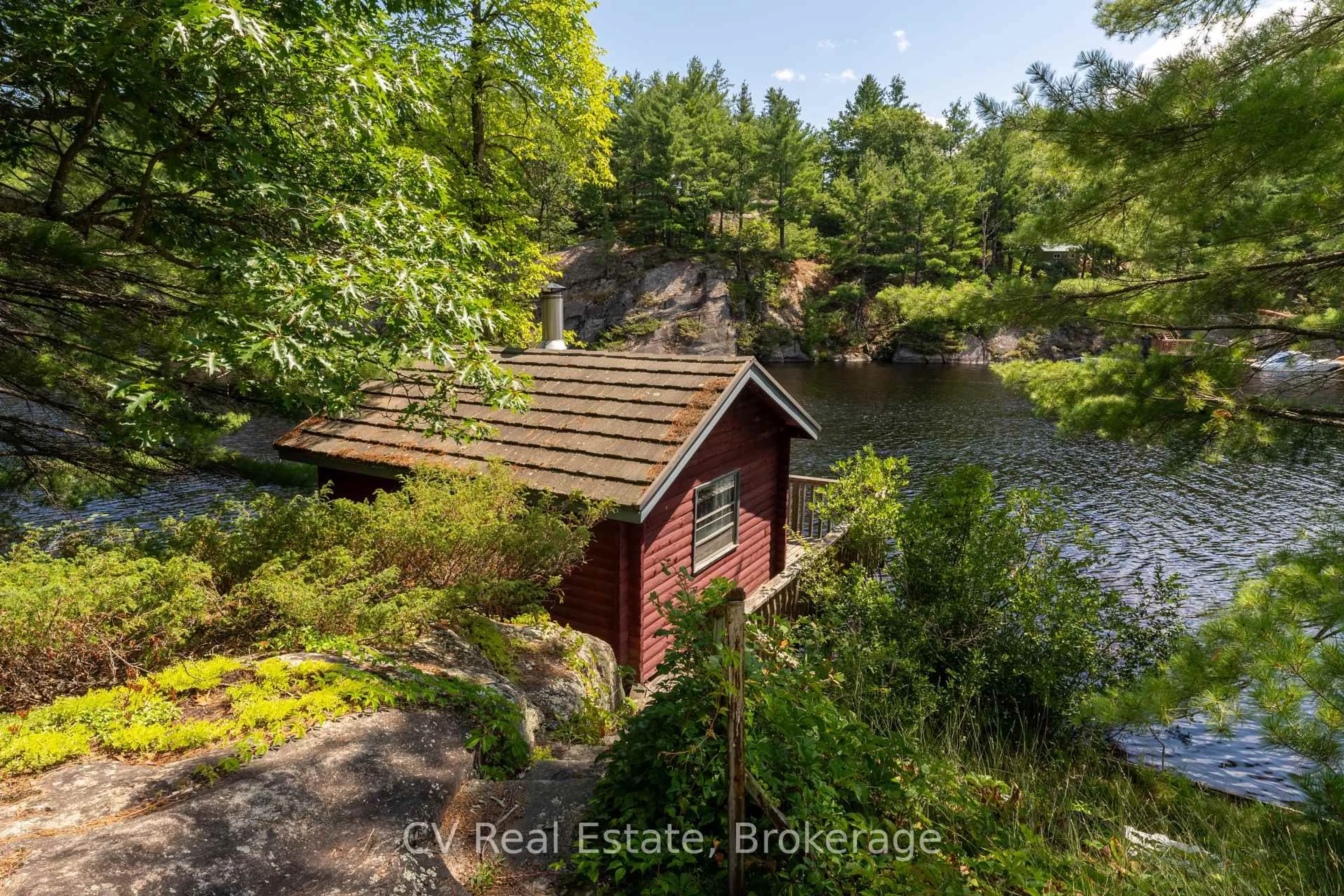 A pic from outside/outdoor area/front of a property/back of a property/a pic from drone, water/lake/river/ocean view for 1037 Sunrise Dr, Gravenhurst Ontario P1P 1R3