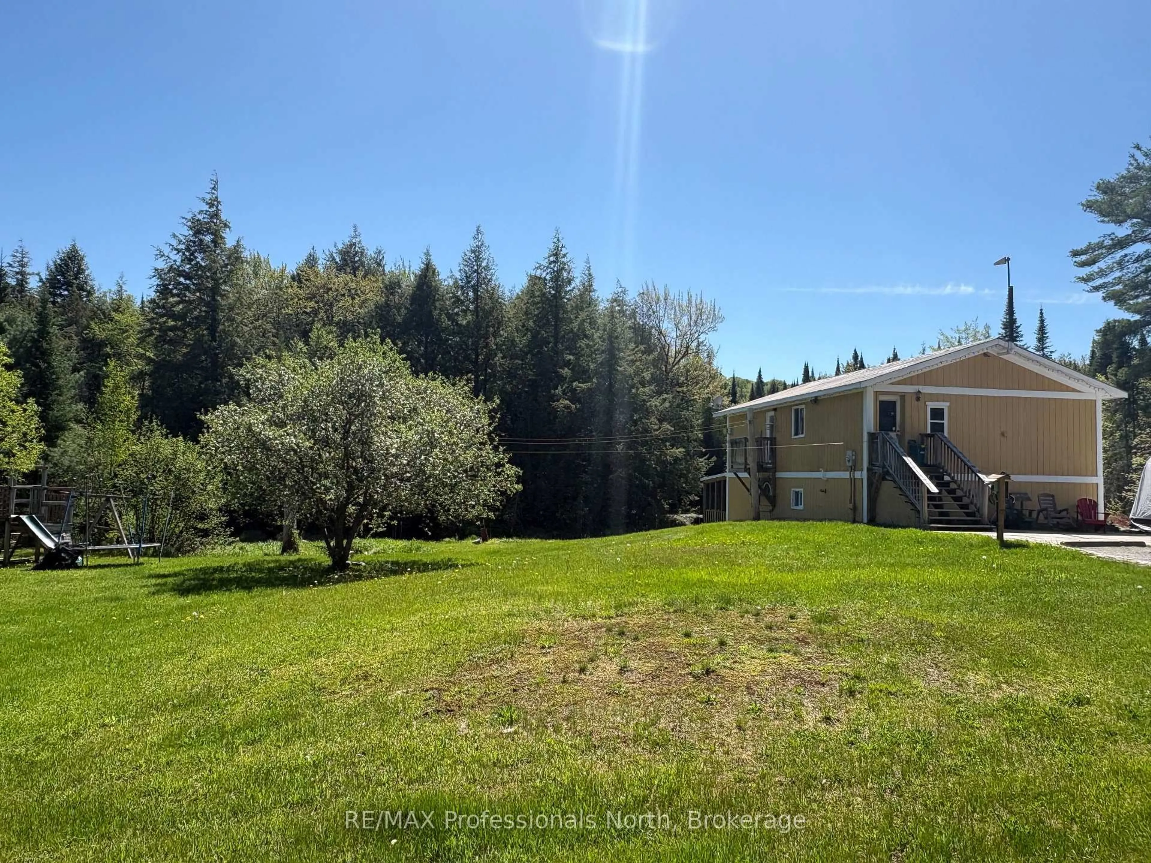 A pic from outside/outdoor area/front of a property/back of a property/a pic from drone, forest/trees view for 2315 Aspdin Rd, Huntsville Ontario P0B 1M0