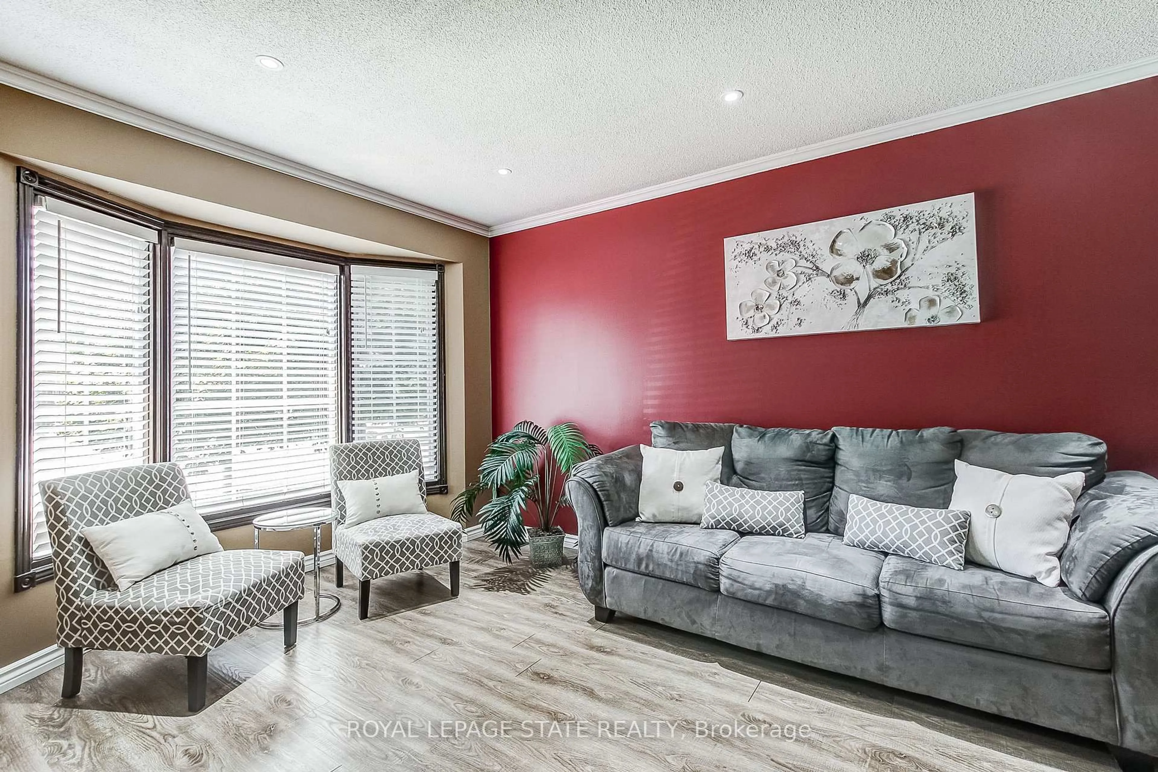 Living room with furniture, wood/laminate floor for 357 Acadia Dr, Hamilton Ontario L8W 3L7
