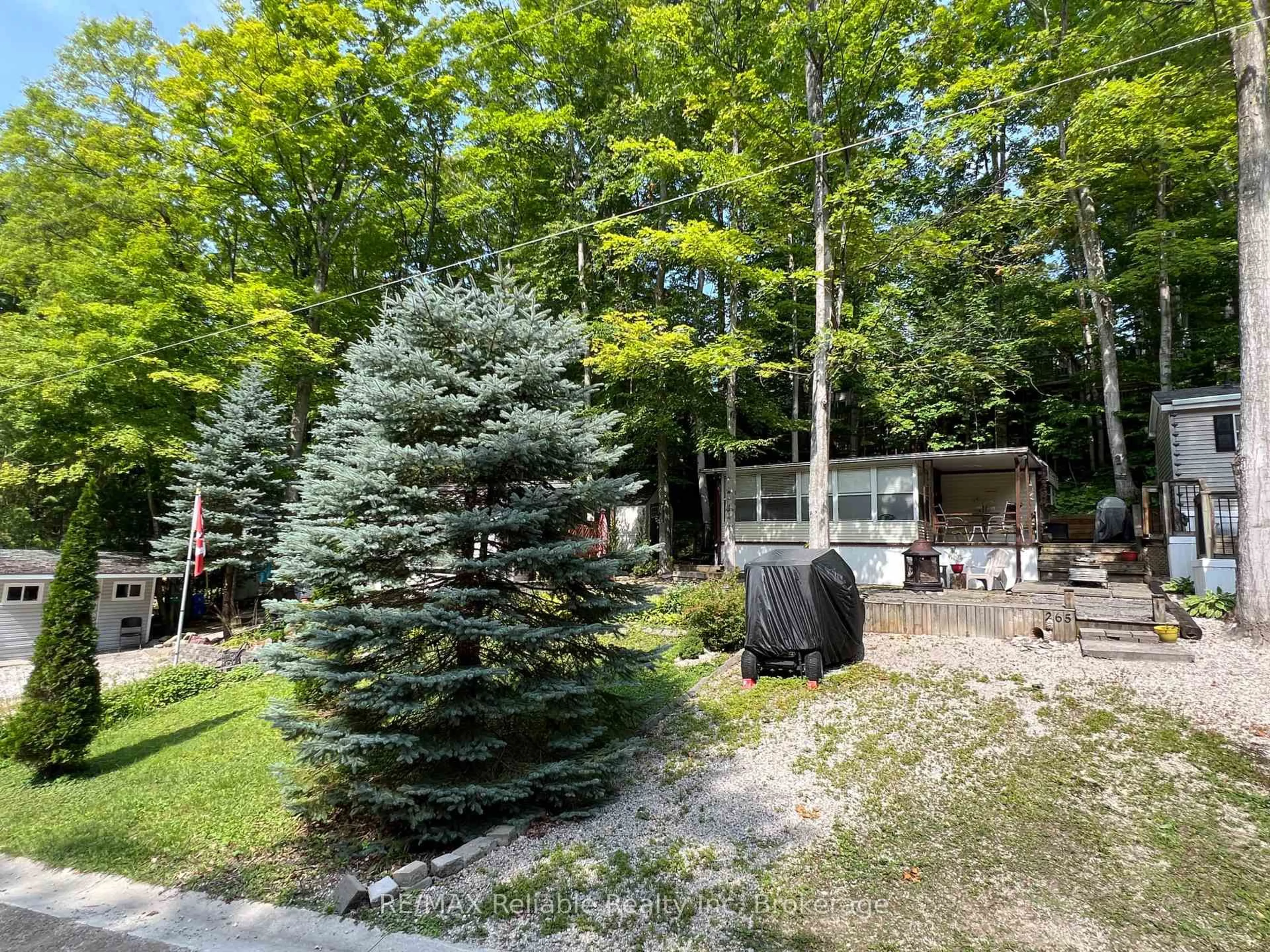 A pic from outside/outdoor area/front of a property/back of a property/a pic from drone, forest/trees view for 76735 Wildwood Line #265, Bluewater Ontario N0M 1G0
