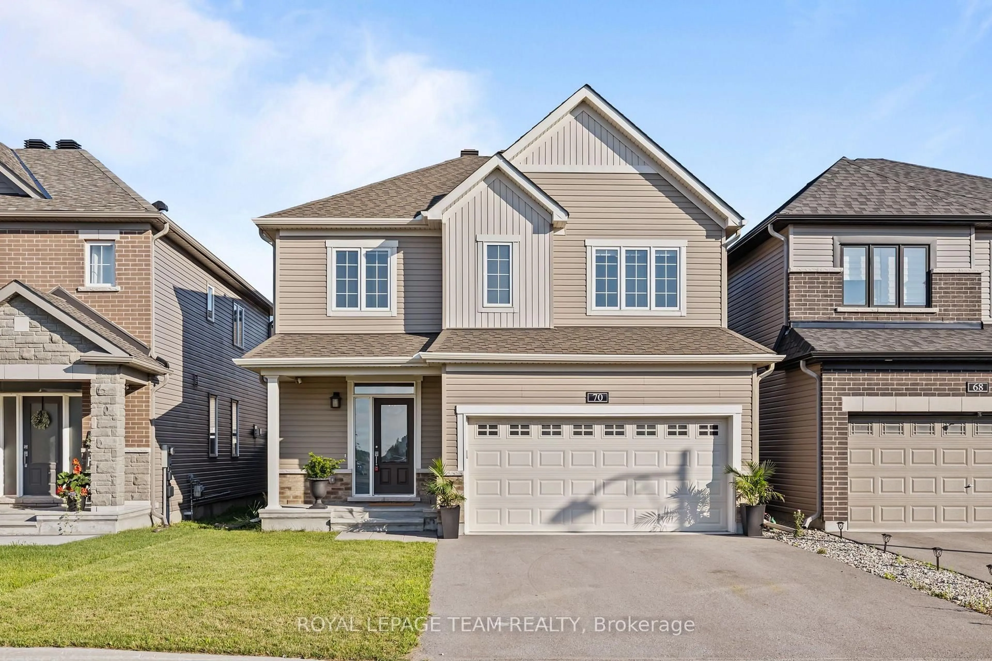 Home with brick exterior material, street for 70 Ralph Erfle Way, Ottawa Ontario K2J 6V5