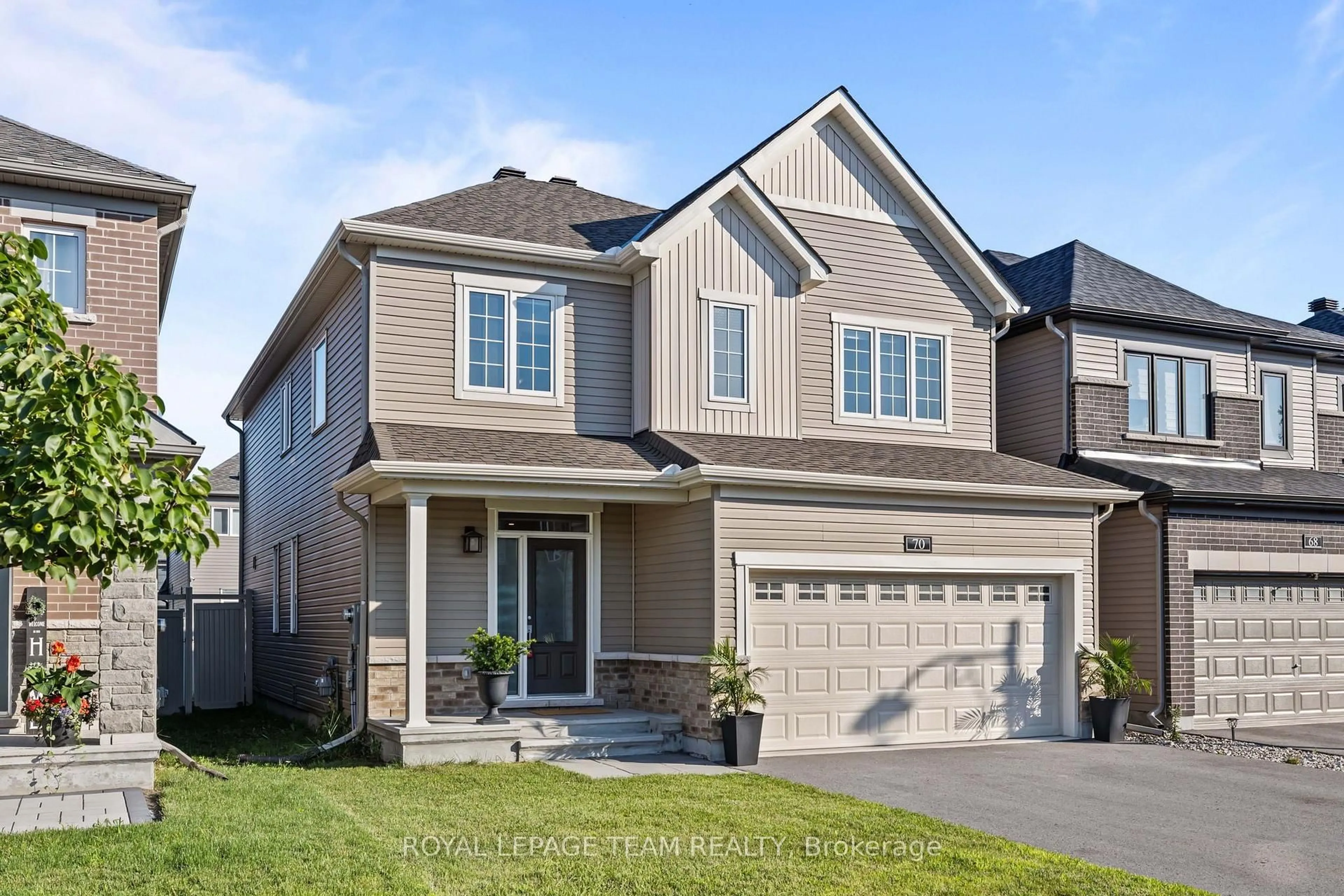 Home with brick exterior material, street for 70 Ralph Erfle Way, Ottawa Ontario K2J 6V5