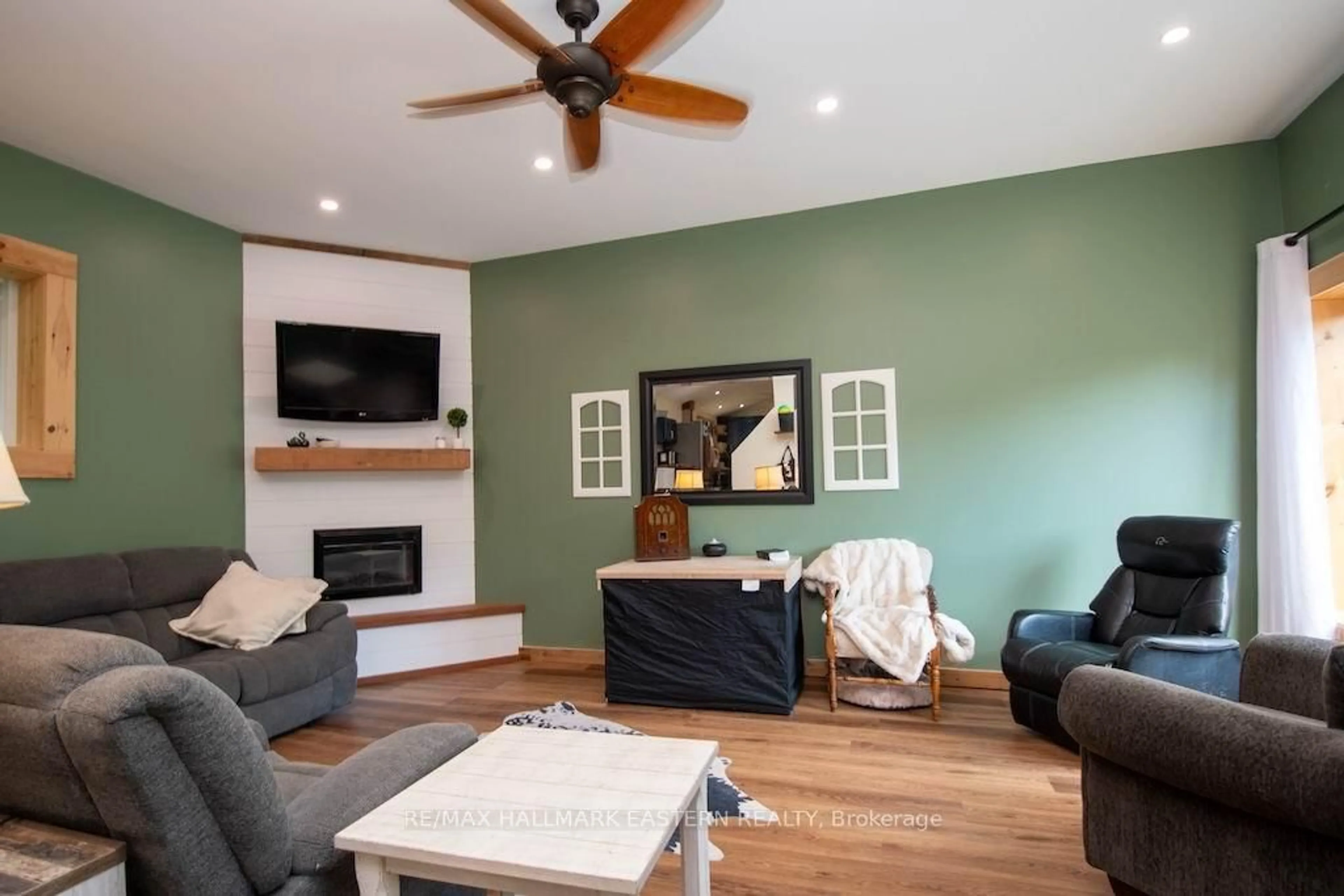 Living room with furniture, wood/laminate floor for 318 & 321 Caves Rd, Douro-Dummer Ontario K0L 3A0