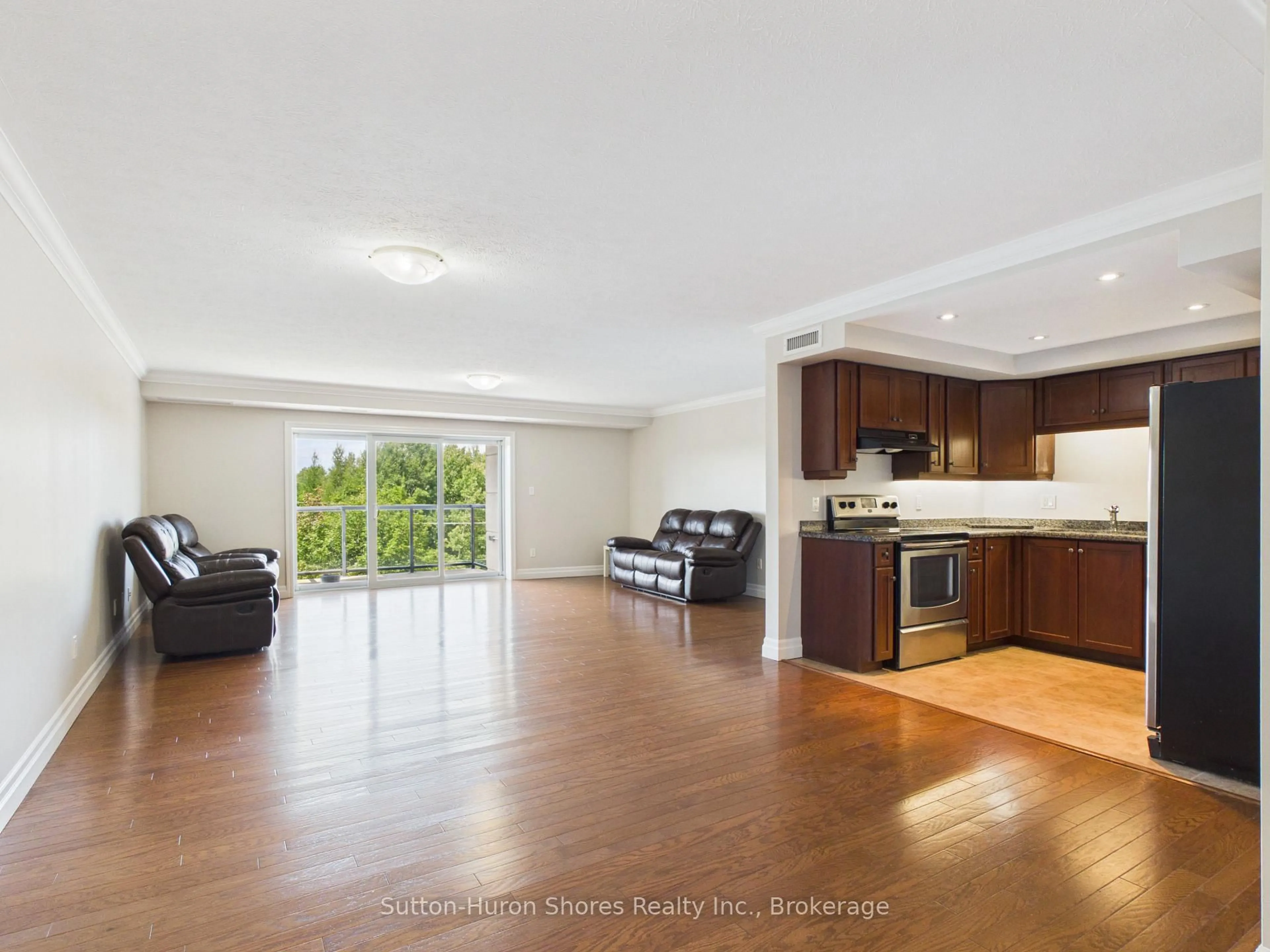 Open concept kitchen, wood/laminate floor for 221 Adelaide St #402, Saugeen Shores Ontario N0H 2L0