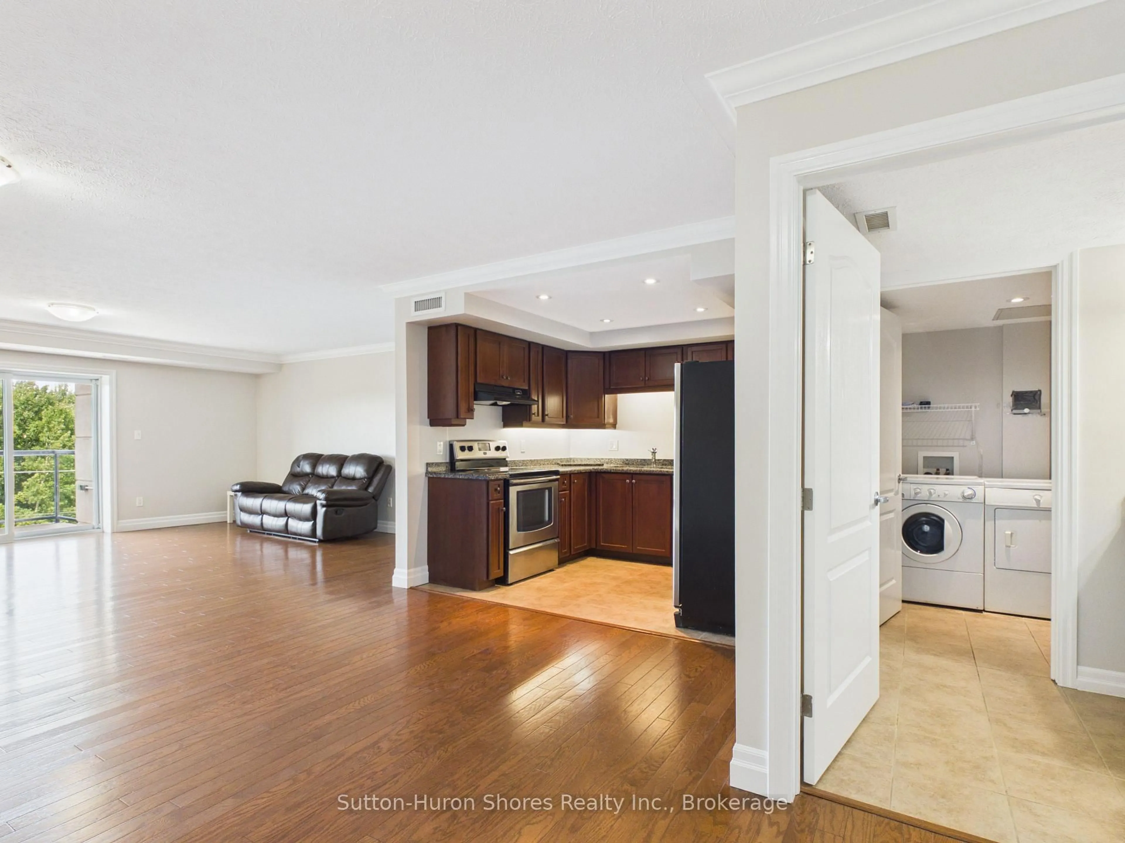 Open concept kitchen, wood/laminate floor for 221 Adelaide St #402, Saugeen Shores Ontario N0H 2L0