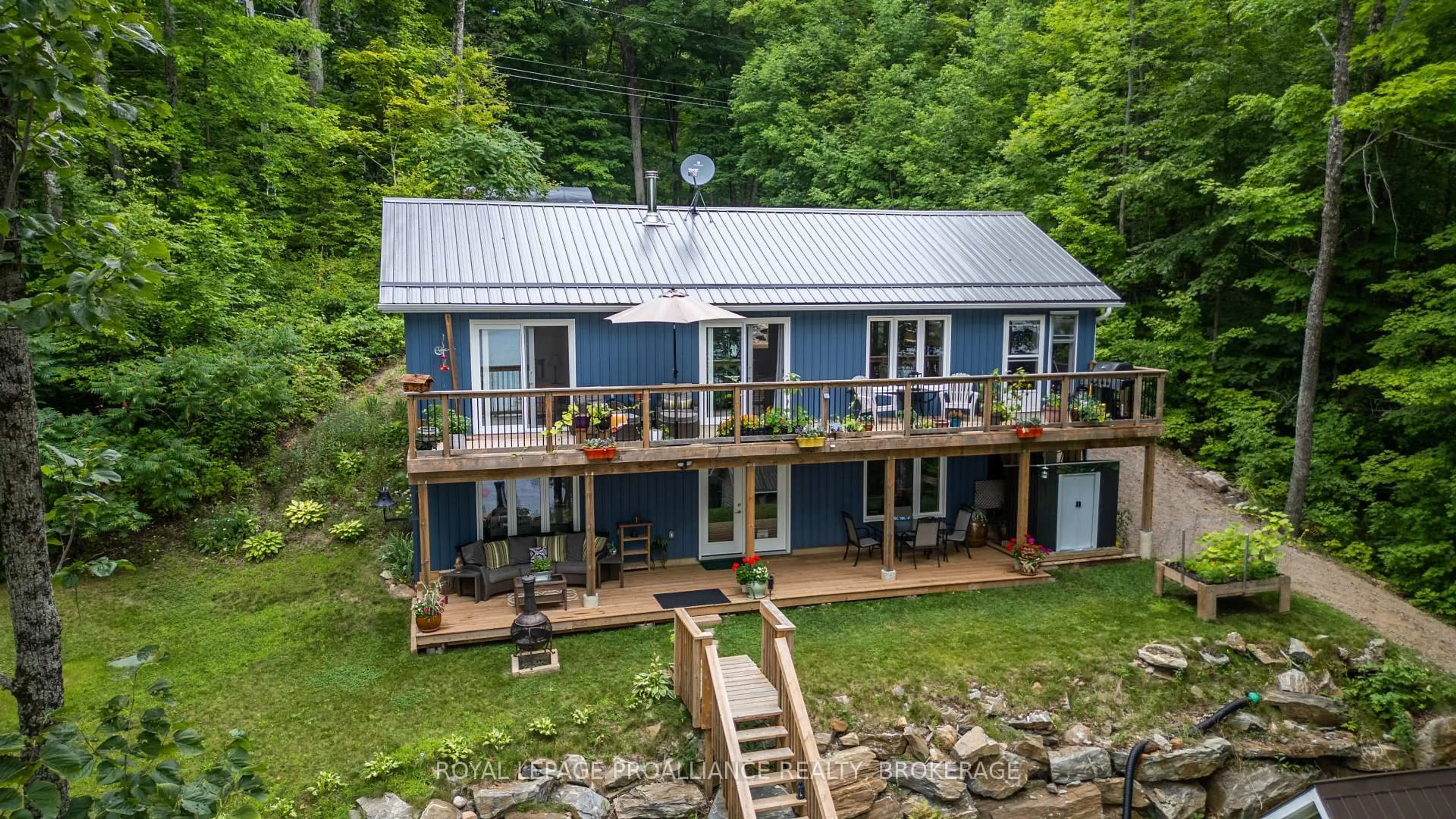 A pic from outside/outdoor area/front of a property/back of a property/a pic from drone, water/lake/river/ocean view for 1099 Almost Lane, Ardoch Ontario K0H 1C0