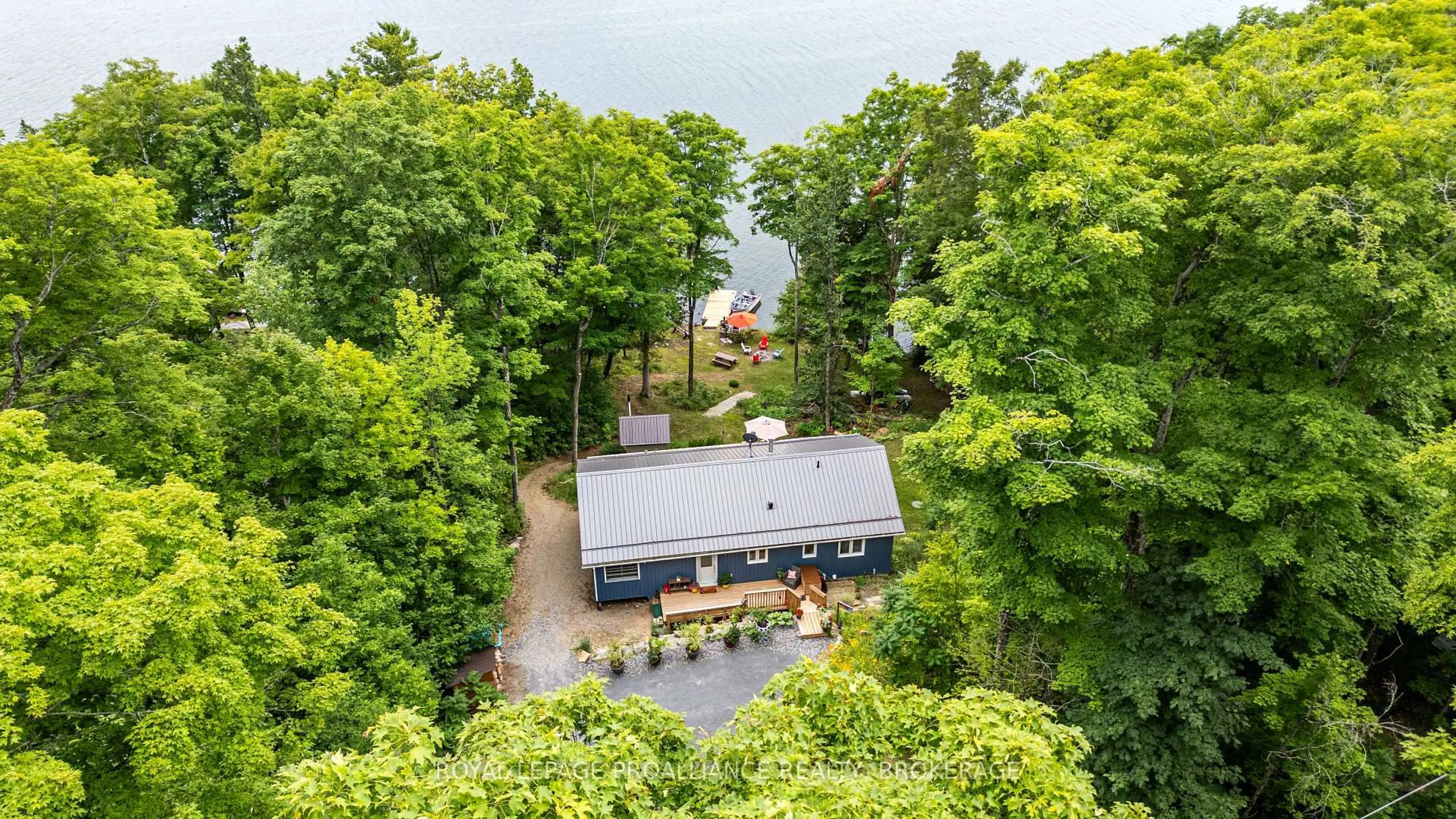 A pic from outside/outdoor area/front of a property/back of a property/a pic from drone, water/lake/river/ocean view for 1099 Almost Lane, Ardoch Ontario K0H 1C0