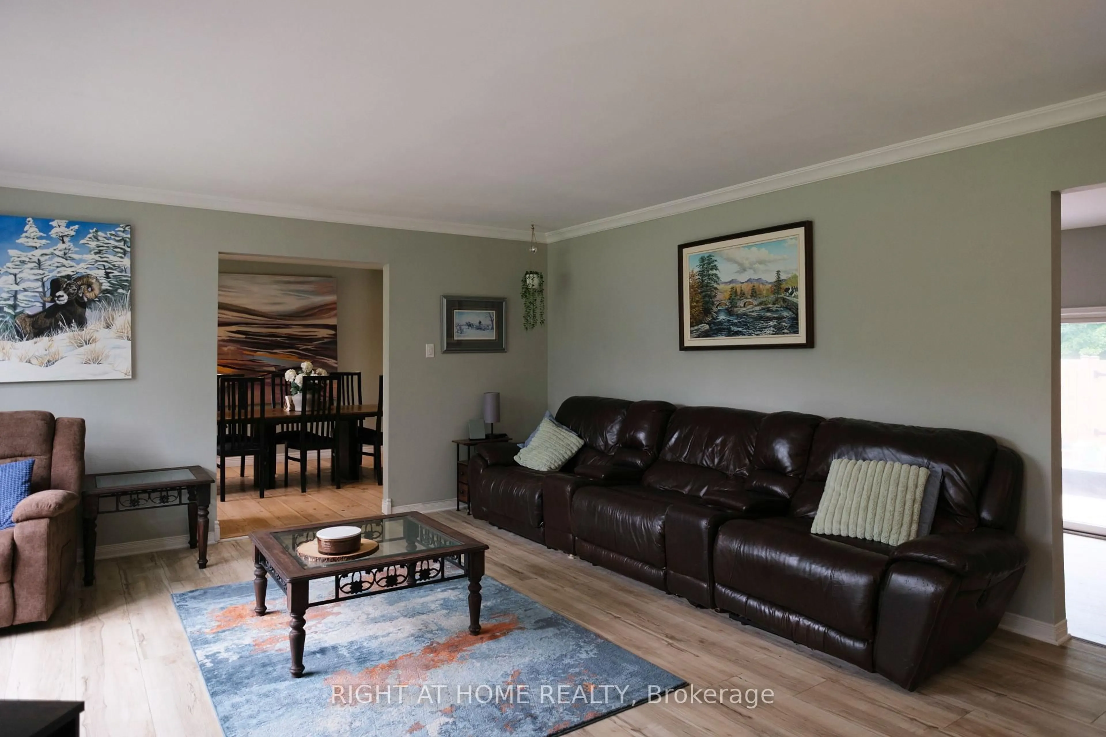 Living room with furniture, wood/laminate floor for 306 Lynx Hollow Dr, Pakenham Ontario K0A 2X0