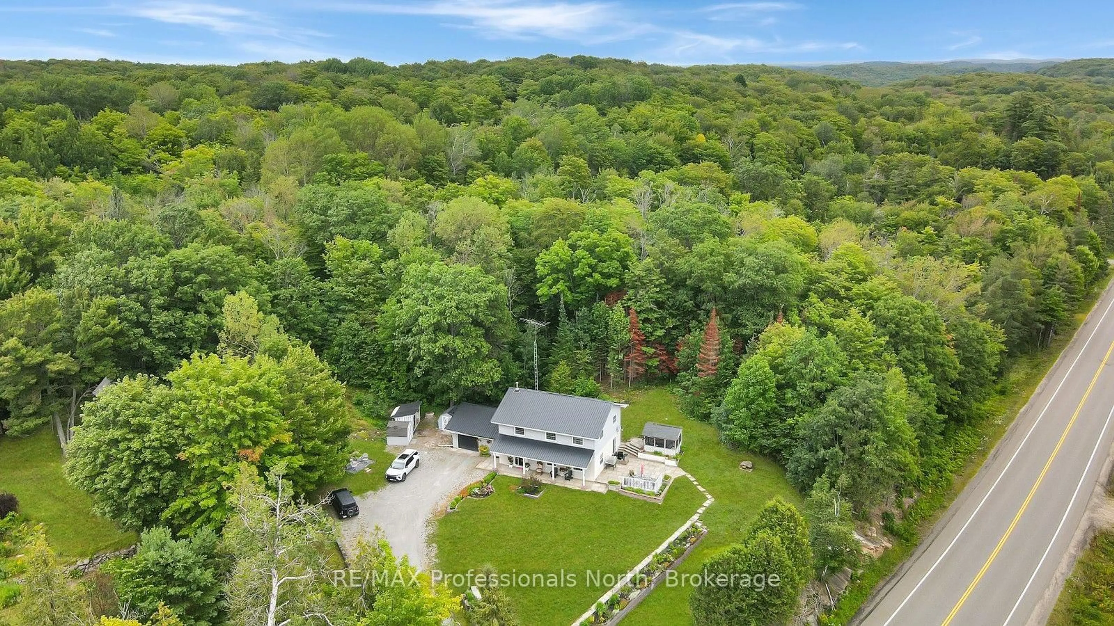 A pic from outside/outdoor area/front of a property/back of a property/a pic from drone, forest/trees view for 14609 Highway 118, Dysart et al Ontario K0M 1S0