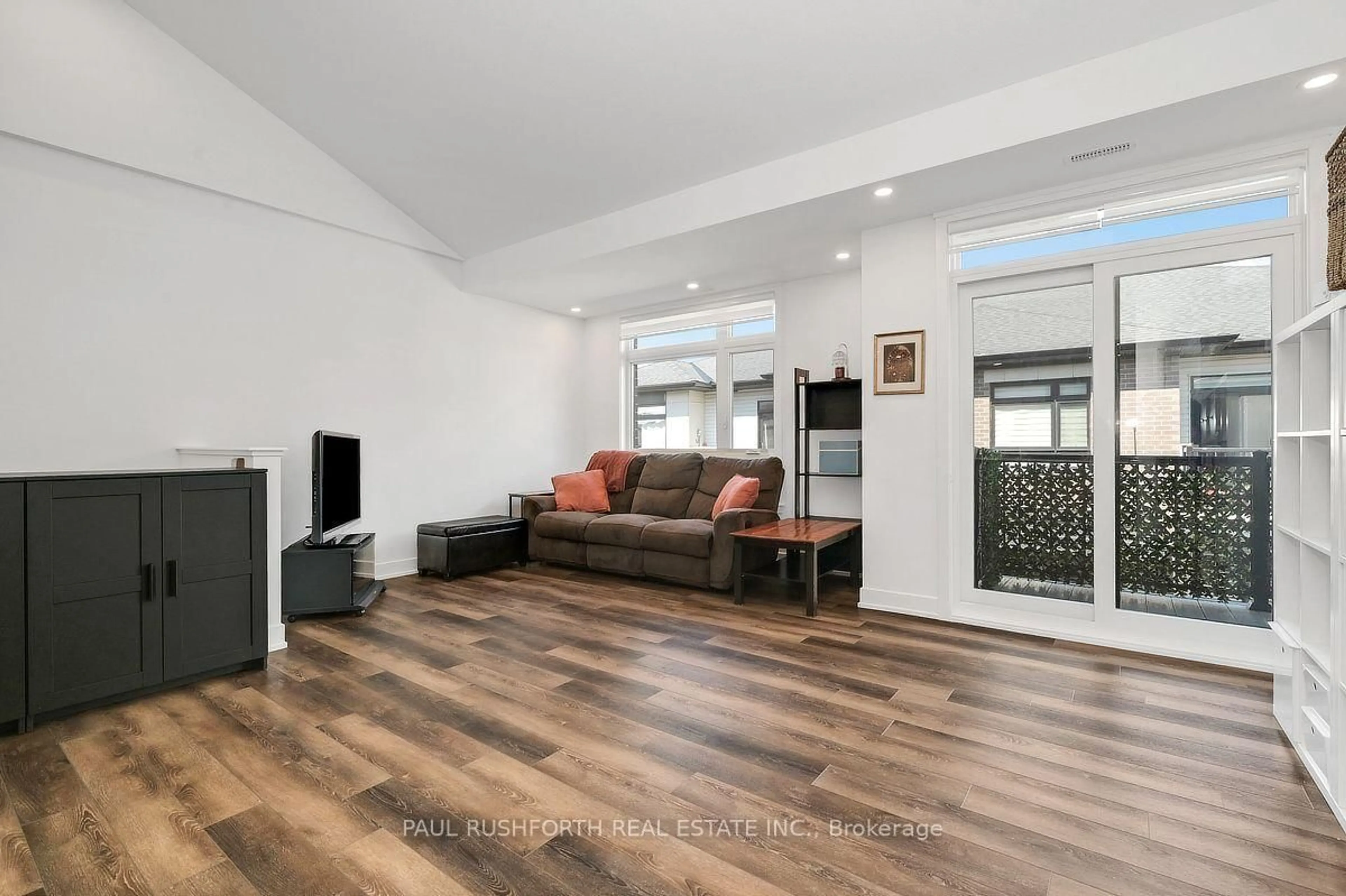 Living room with furniture, wood/laminate floor for 310 Tulum Cres #J, Ottawa Ontario K2S 2Y4