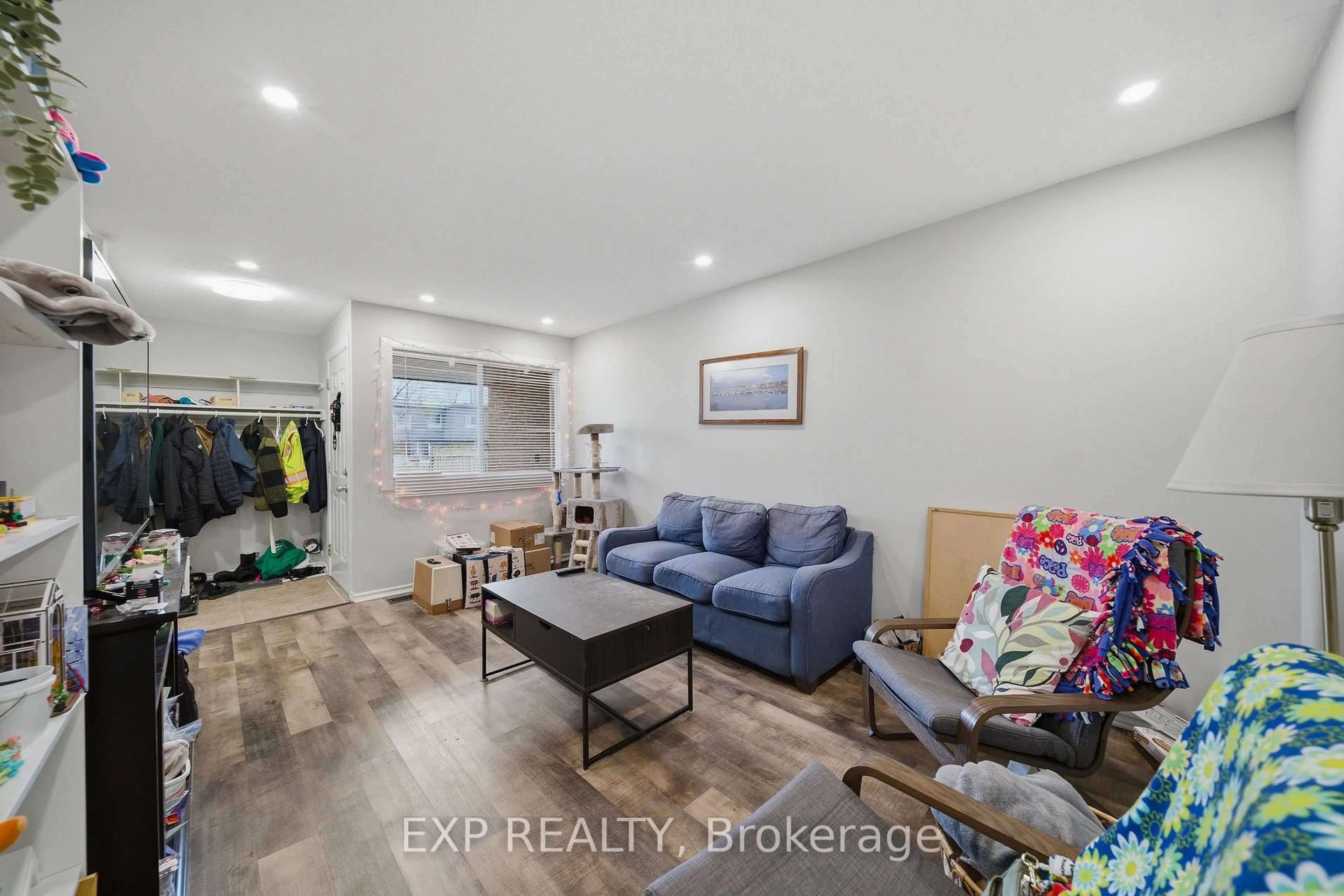 Living room with furniture, wood/laminate floor for 1675 Heatherington Rd #11, Ottawa Ontario K1V 8V8
