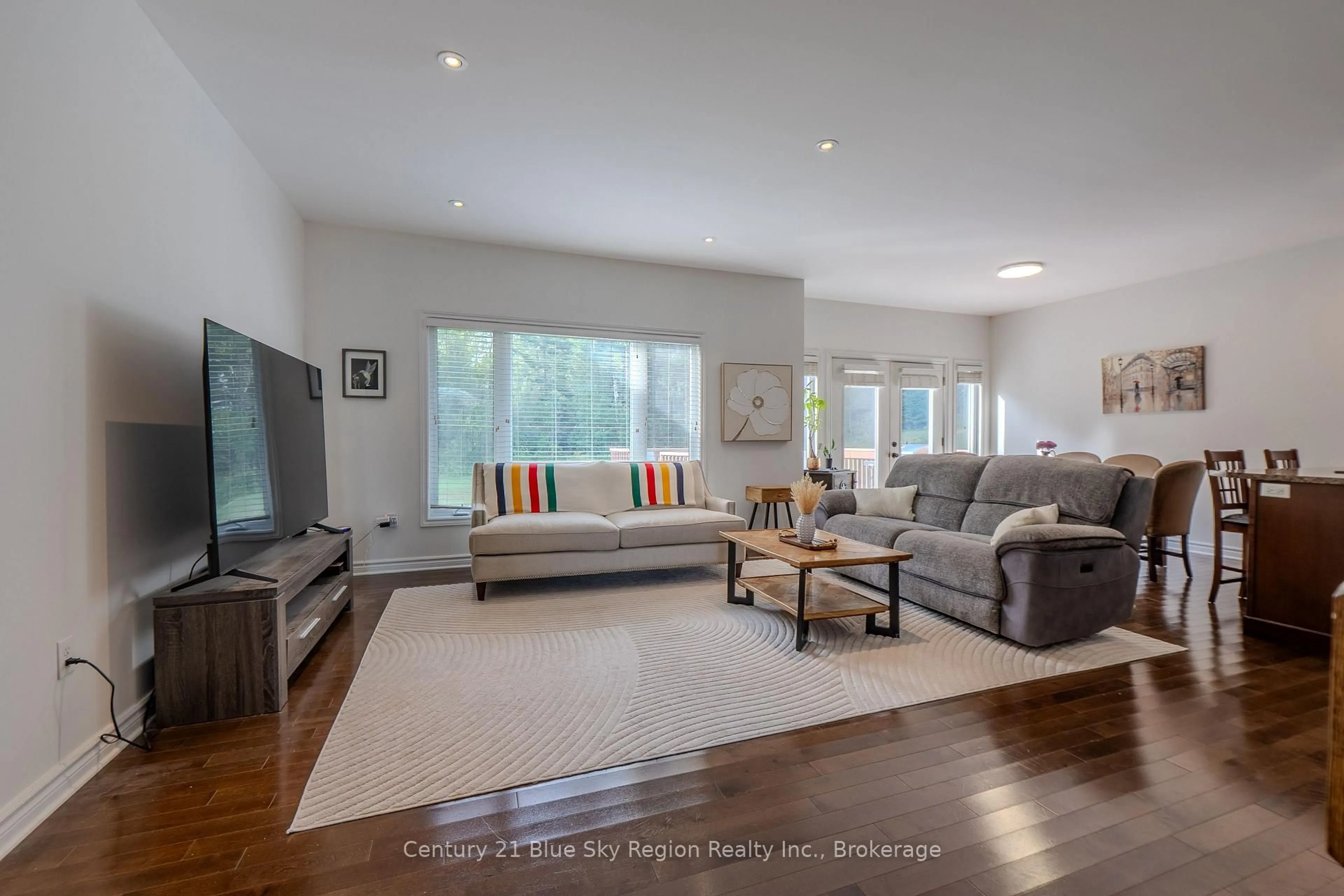 Living room with furniture, wood/laminate floor for 24 Osprey Cres, Callander Ontario P0H 1H0