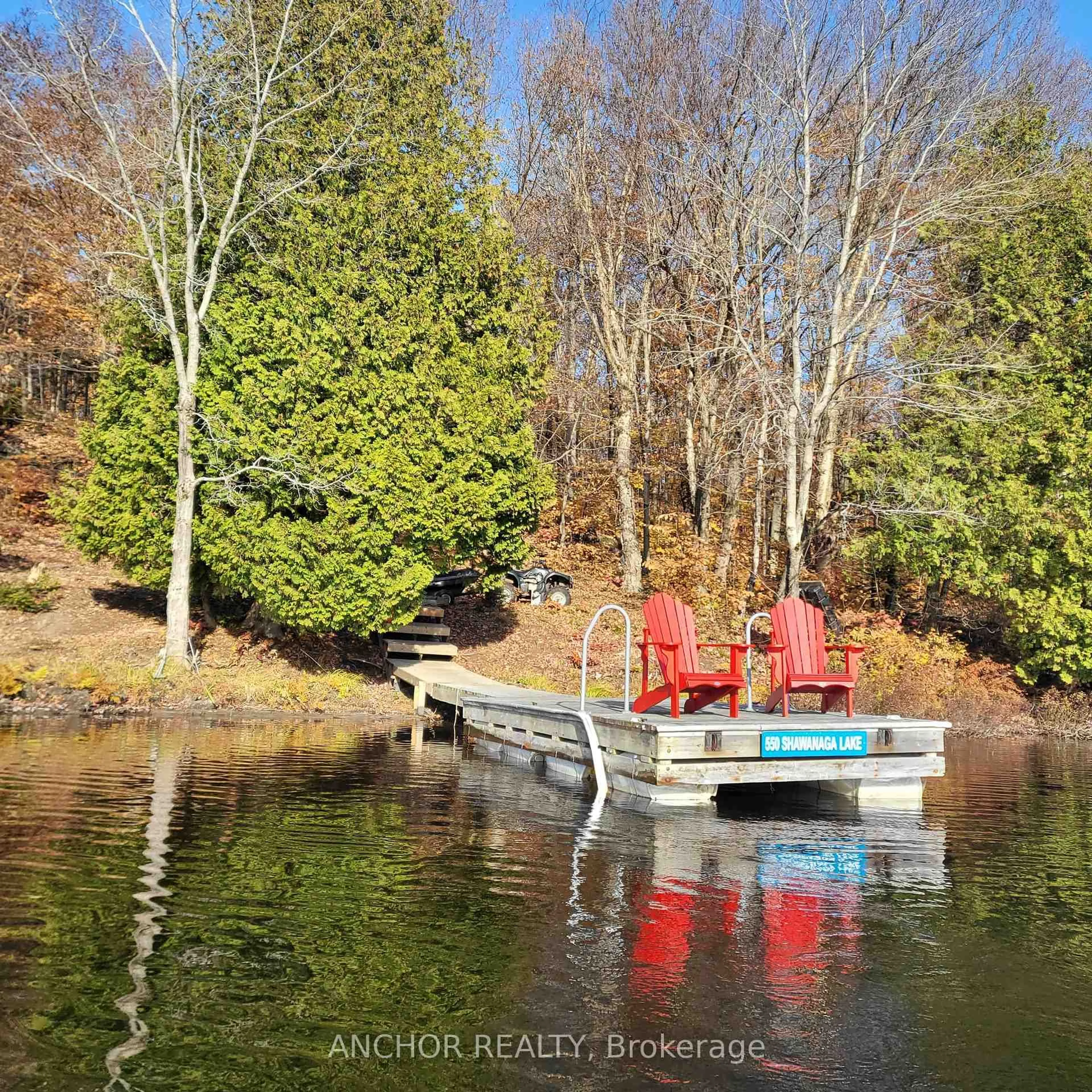 A pic from outside/outdoor area/front of a property/back of a property/a pic from drone, water/lake/river/ocean view for 550 Shawanaga Lake, McDougall Ontario P0A 1G0