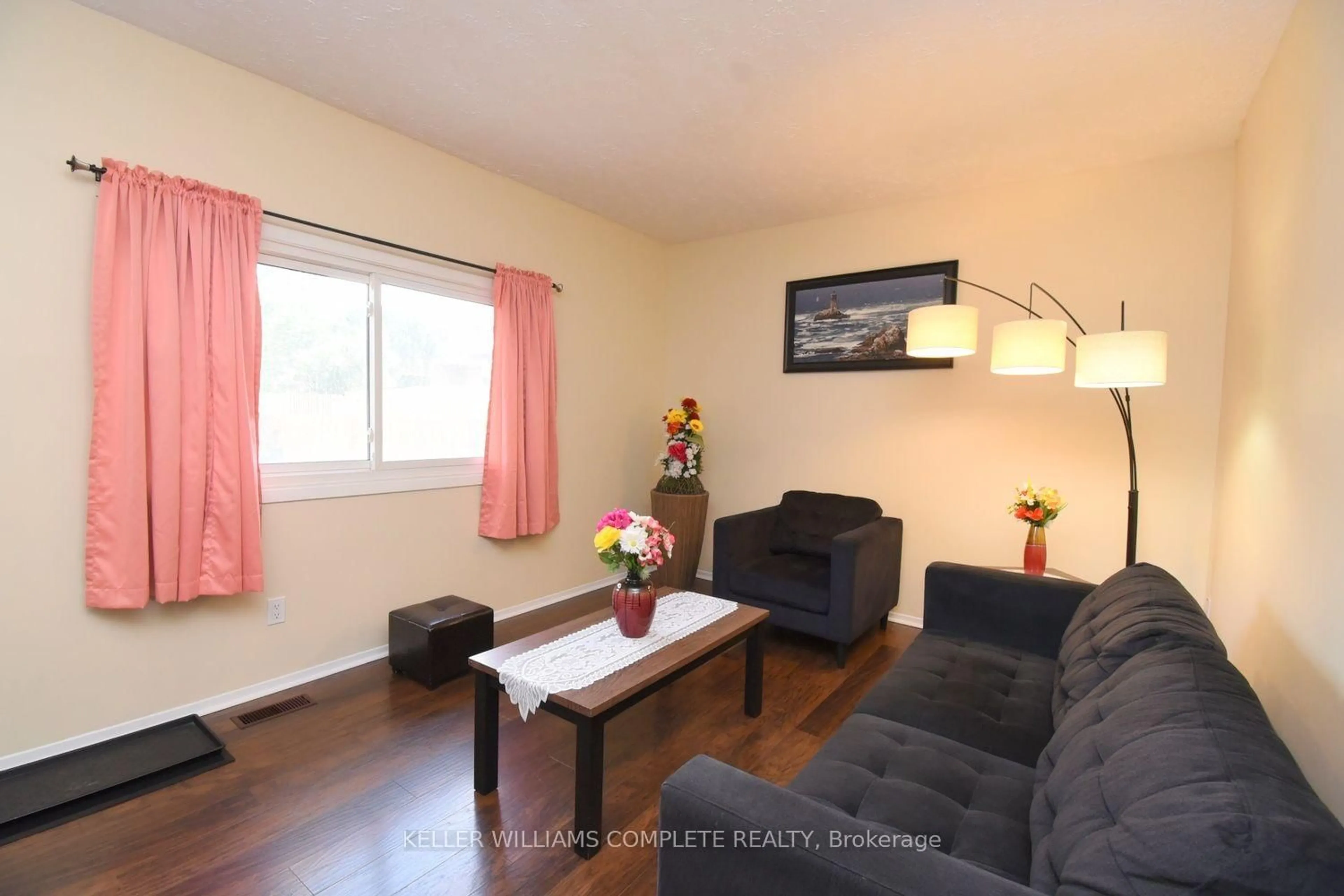 Living room with furniture, wood/laminate floor for 185 DENISTOUN St #116, Welland Ontario L3C 6J6