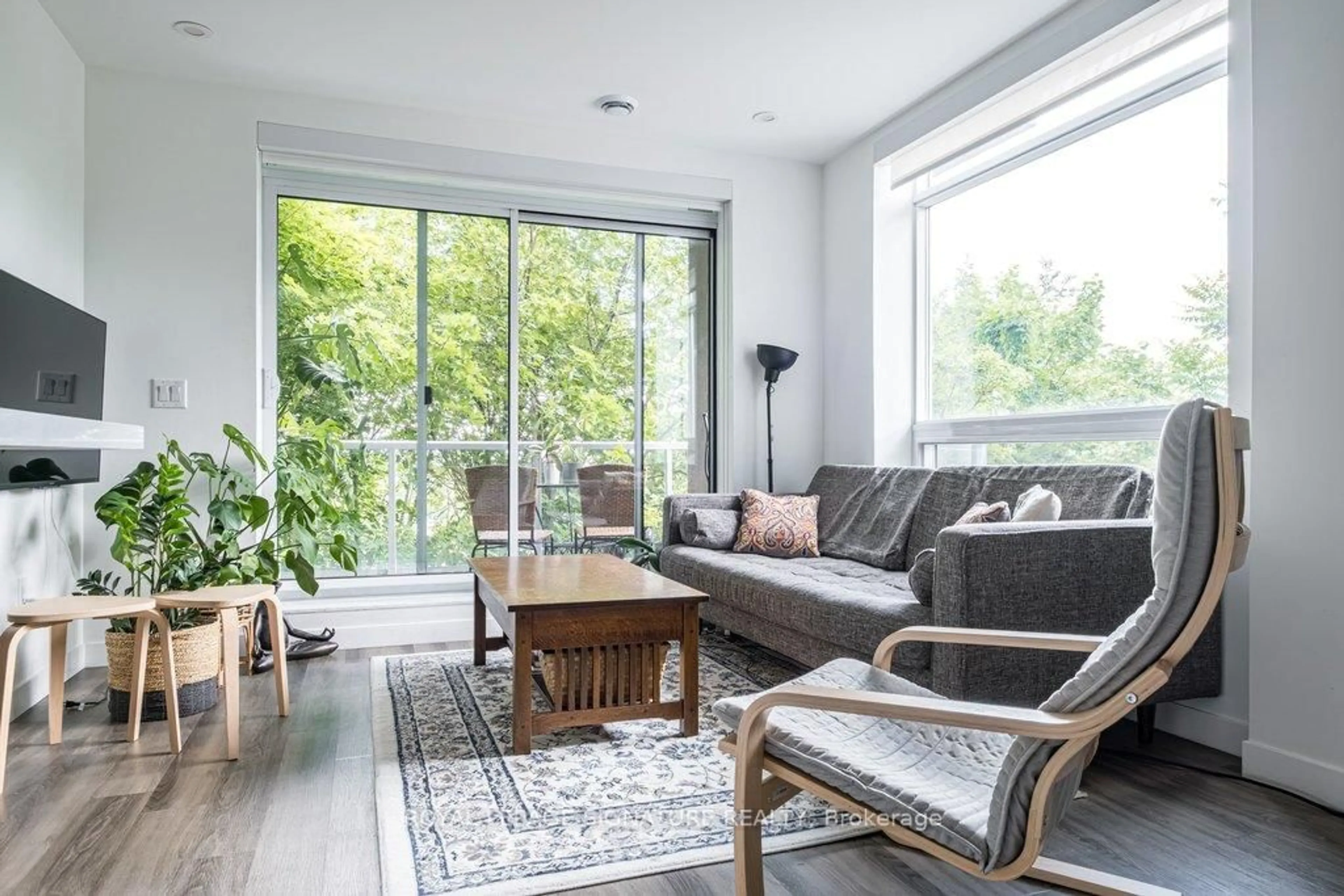 Living room with furniture, wood/laminate floor for 479 Charlton Ave #204, Hamilton Ontario L8N 0B4