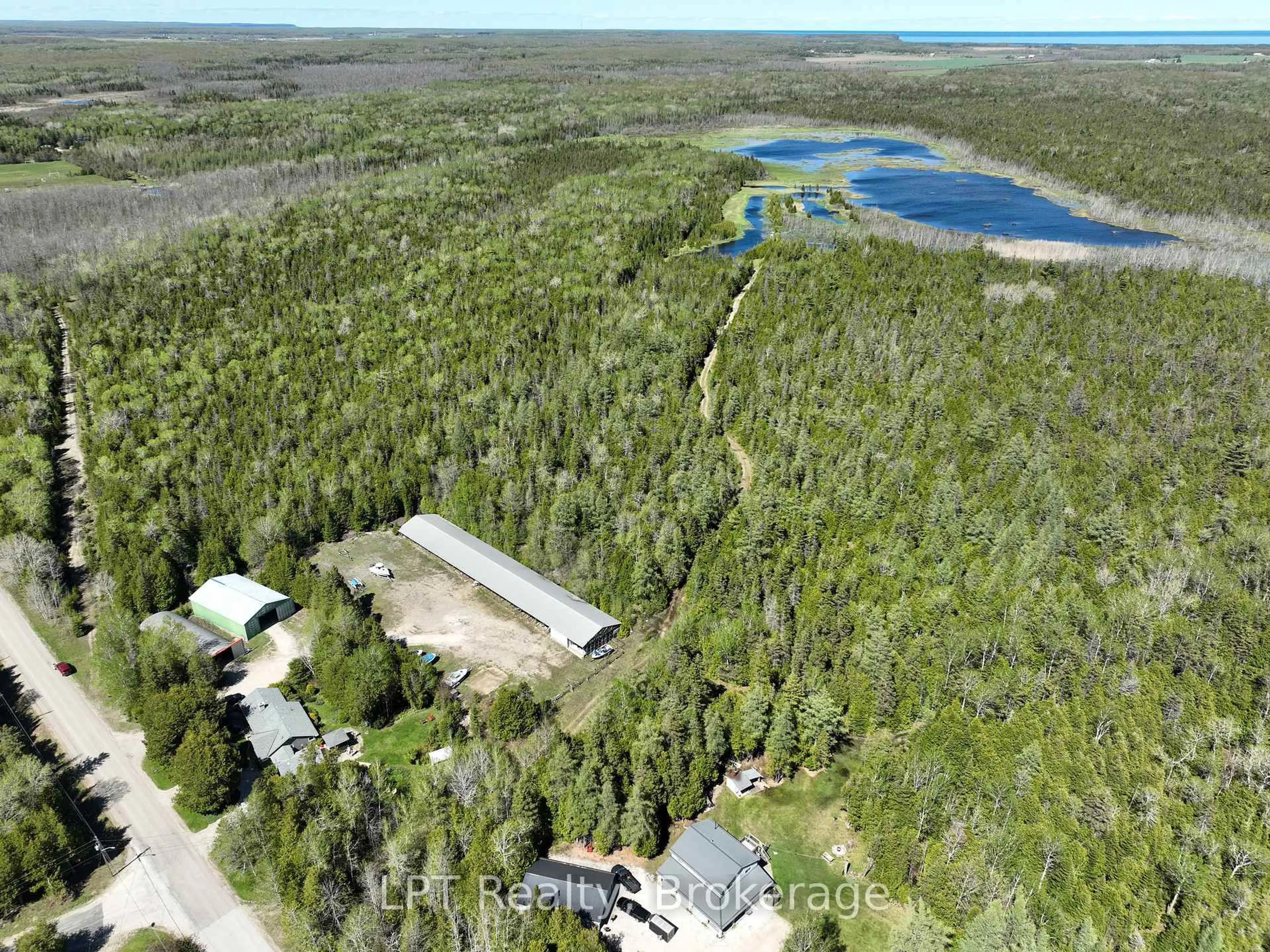 A pic from outside/outdoor area/front of a property/back of a property/a pic from drone, forest/trees view for 158 Stokes Bay Rd, Northern Bruce Peninsula Ontario N0H 1W0