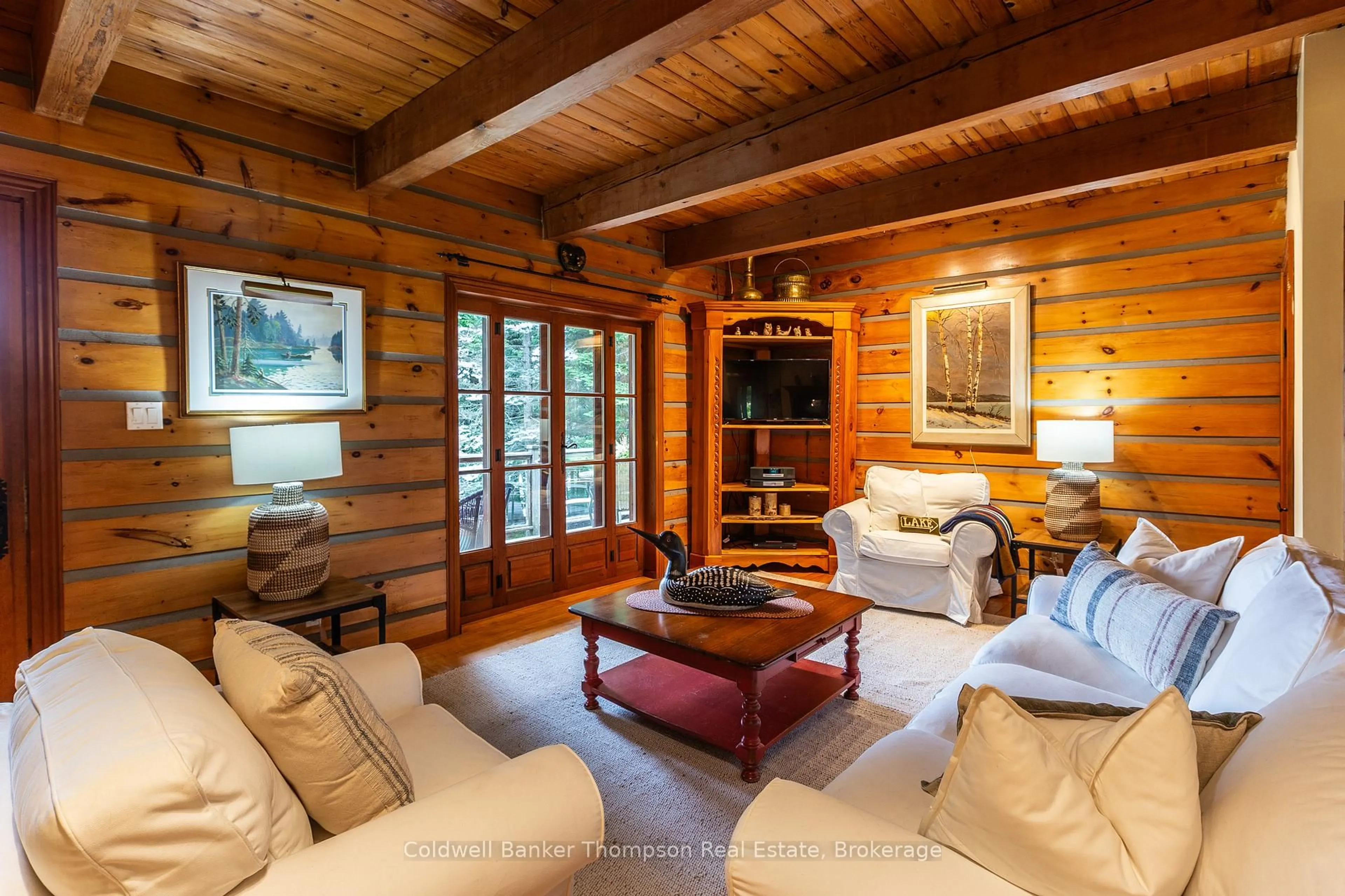 Living room with furniture, wood/laminate floor for 1028 Clarks Dr, Lake of Bays Ontario P0A 1H0