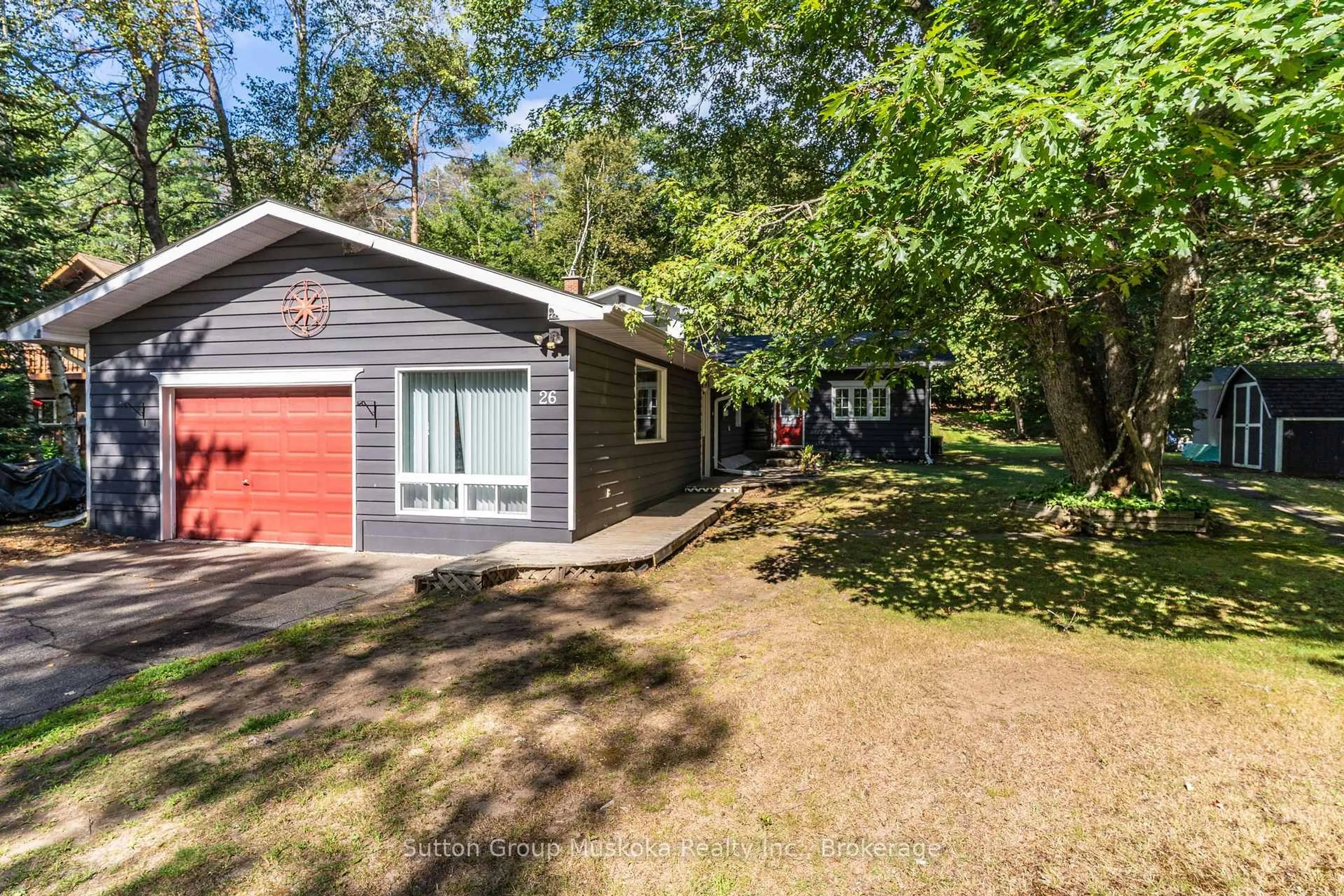 A pic from outside/outdoor area/front of a property/back of a property/a pic from drone, forest/trees view for 26 Sugar Maple Lane, Huntsville Ontario P0B 1L0