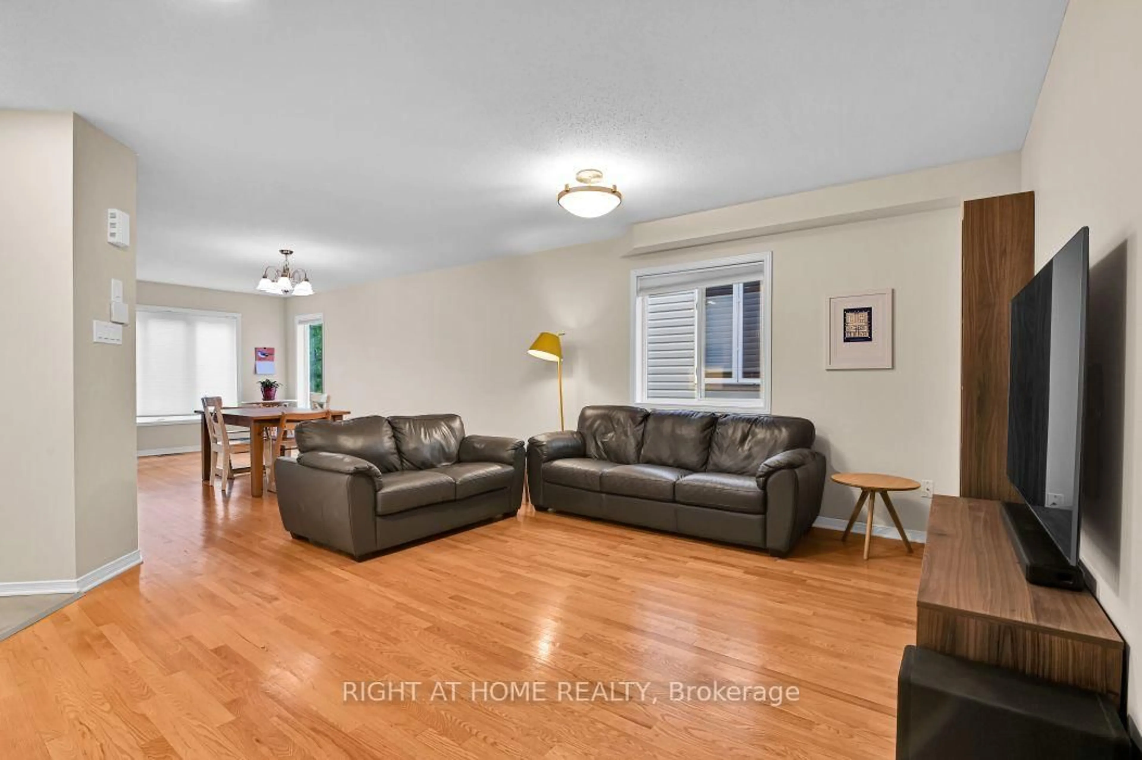 Living room with furniture, wood/laminate floor for 184 Carwood Circ, Ottawa Ontario K1K 4V4