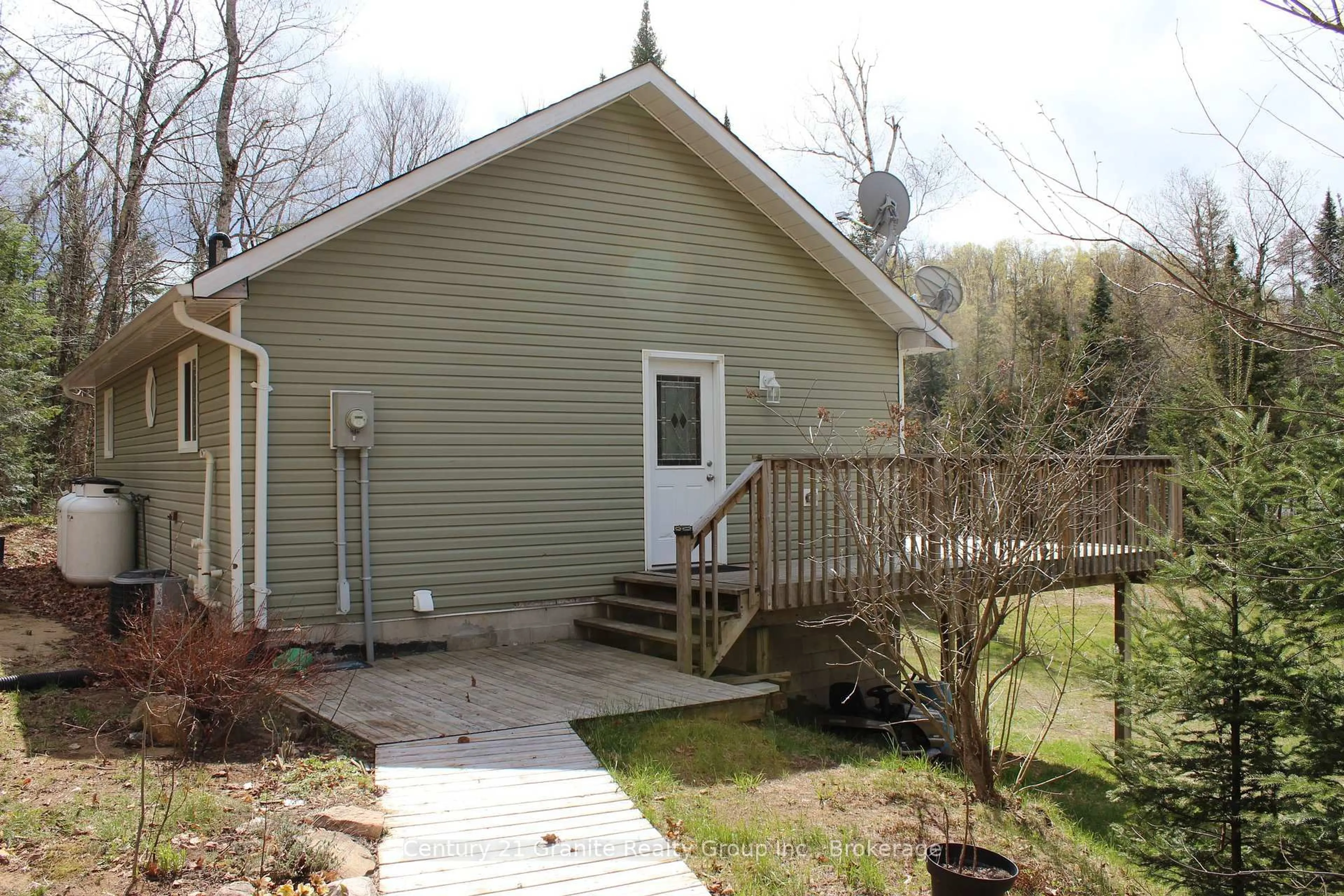 Home with vinyl exterior material, street for 1037 Andek Tr, Highlands East Ontario K0M 1X0