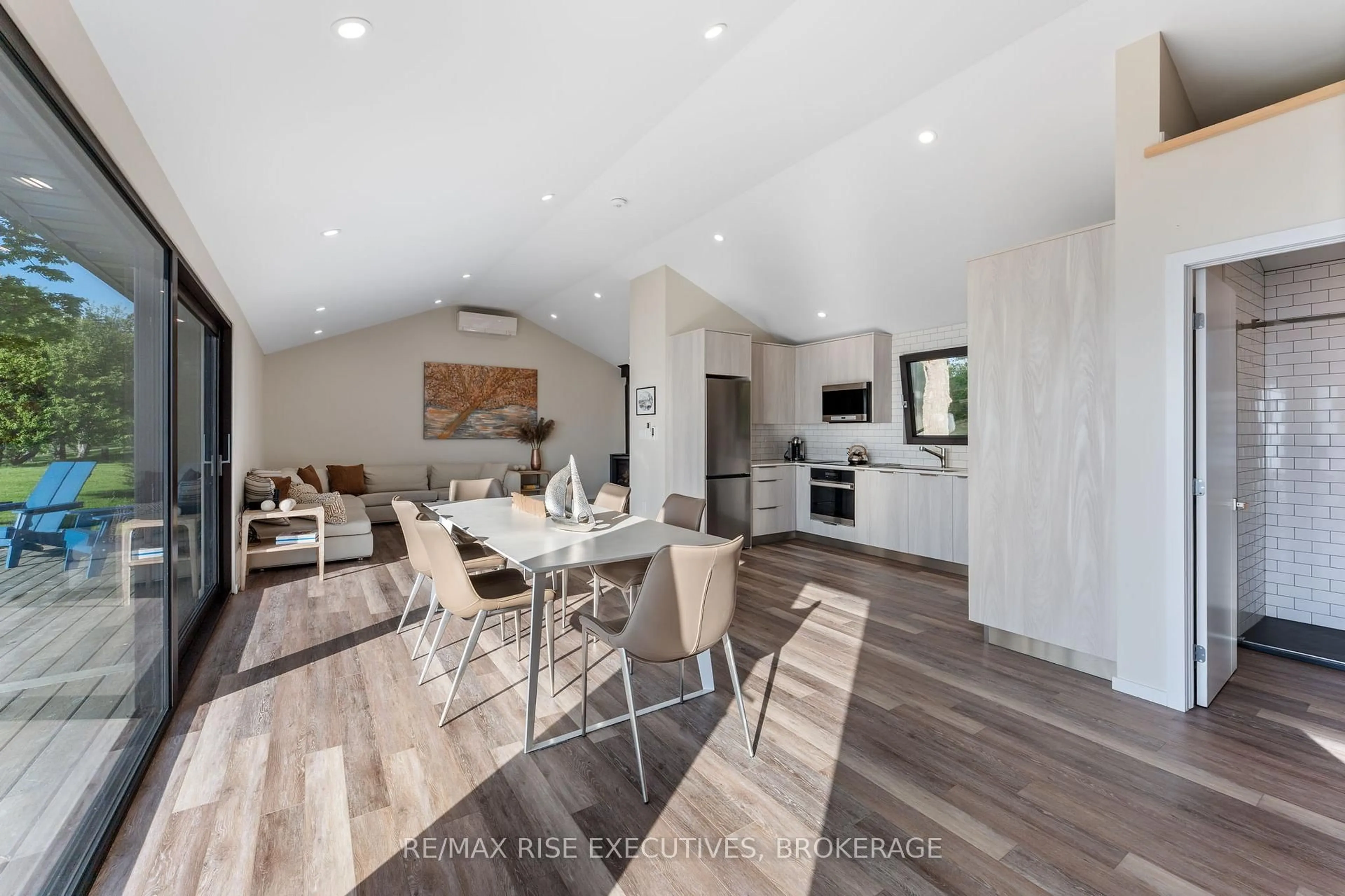 Open concept kitchen, wood/laminate floor for 682 Salmon Point Rd, Prince Edward County Ontario K0K 1P0