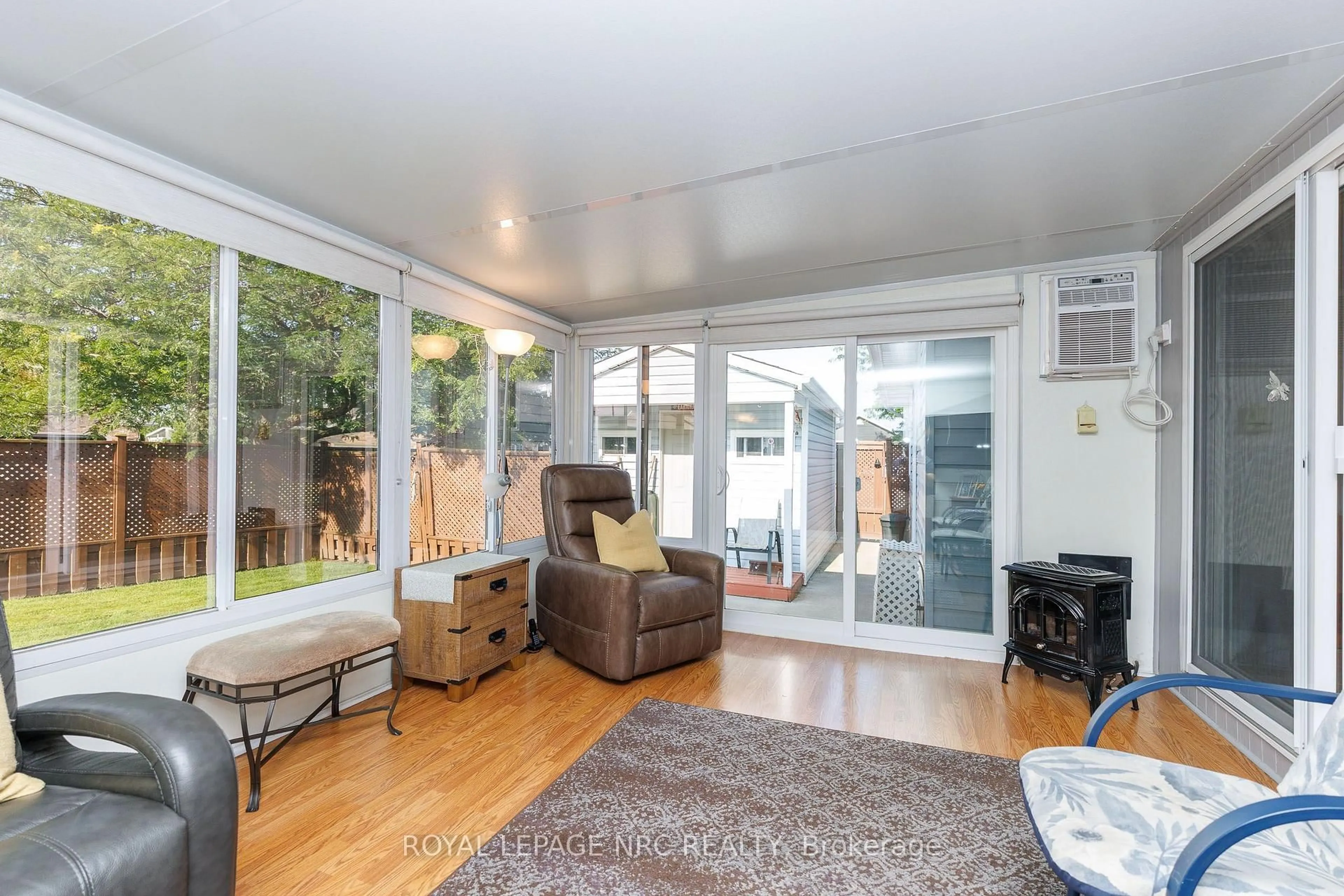 Living room with furniture, wood/laminate floor for 15 Foxhill Cres, St. Catharines Ontario L2S 3T9